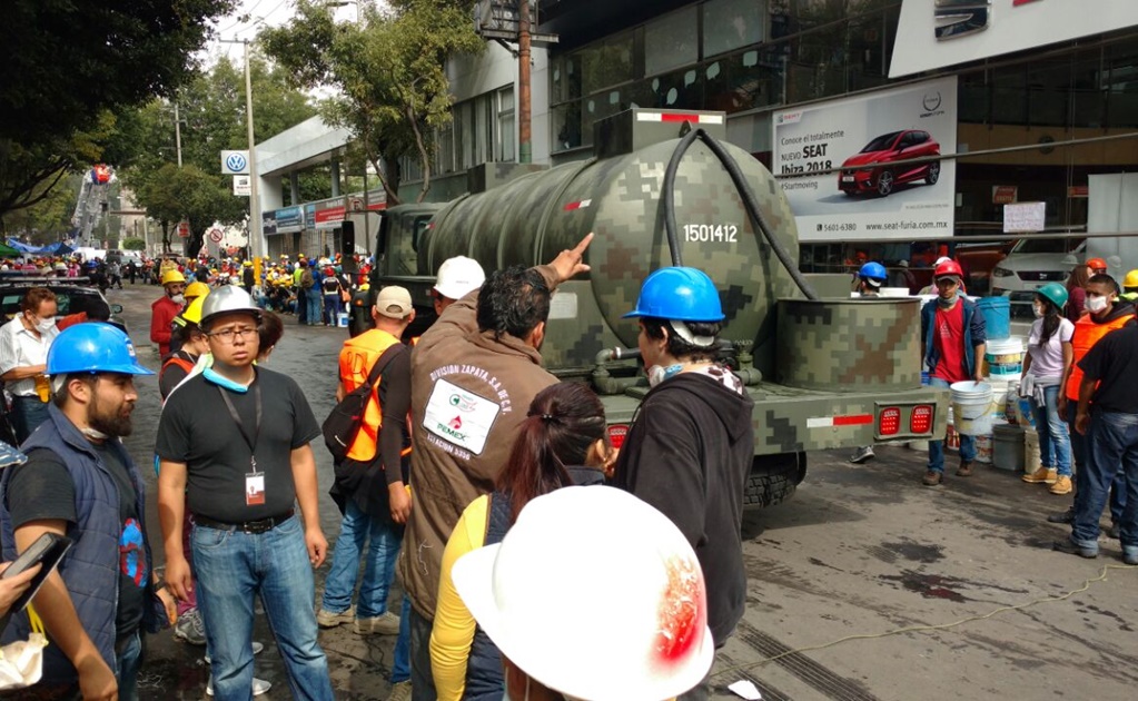 Continúa conato de incendio en escombros de edificio en Petén