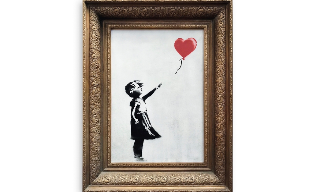 Obra de Banksy se autodestruye en una subasta
