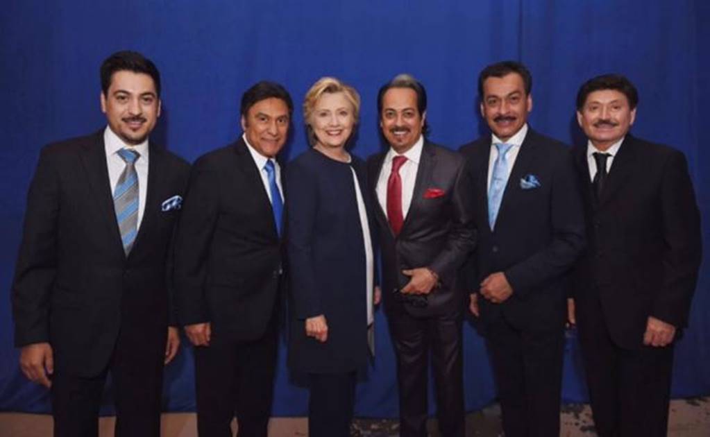 Los Tigres del Norte and Hillary Clinton pose together in a photo 