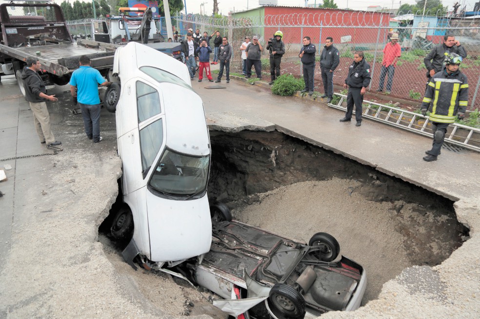 Caen dos automóviles en socavón de Ecatepec