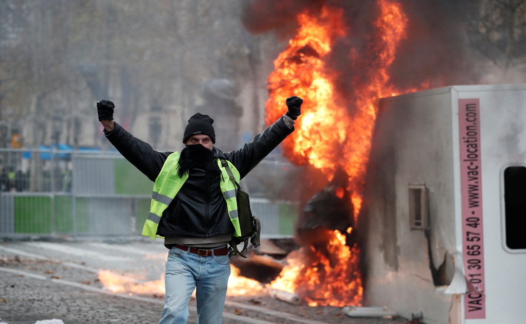 France suspends fuel tax increases after weeks of unrest