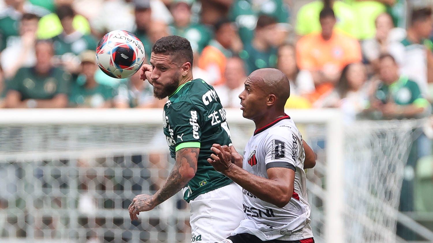 Rafael Navarro of Palmeiras competes for the ball with Claudinho