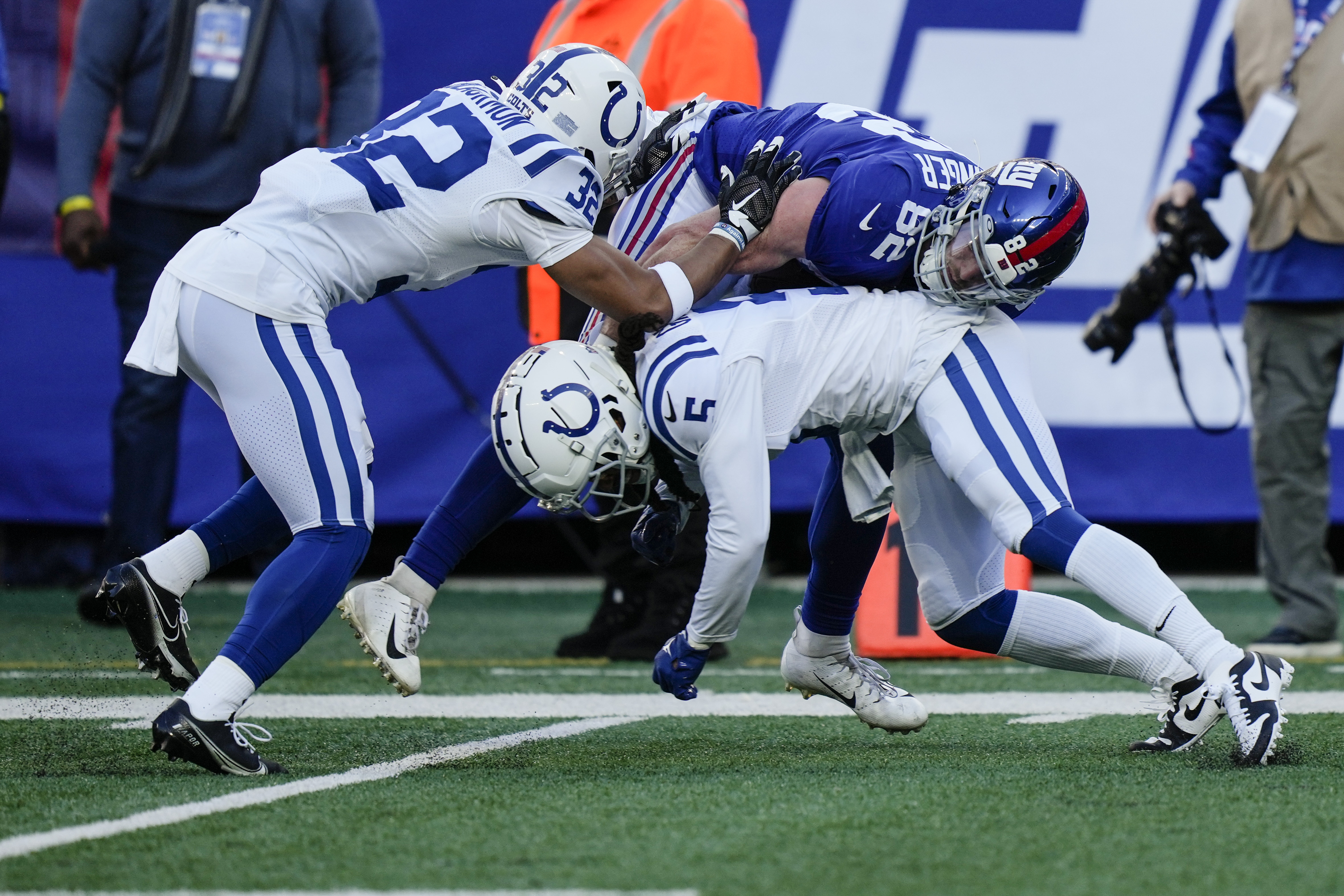 January 1, 2023, East Rutherford, New Jersey, USA: New York Giants  quarterback Daniel Jones (8) scores a touchdown after taking a hit by  Indianapolis Colts linebacker Bobby Okereke (58) fduring a NFL