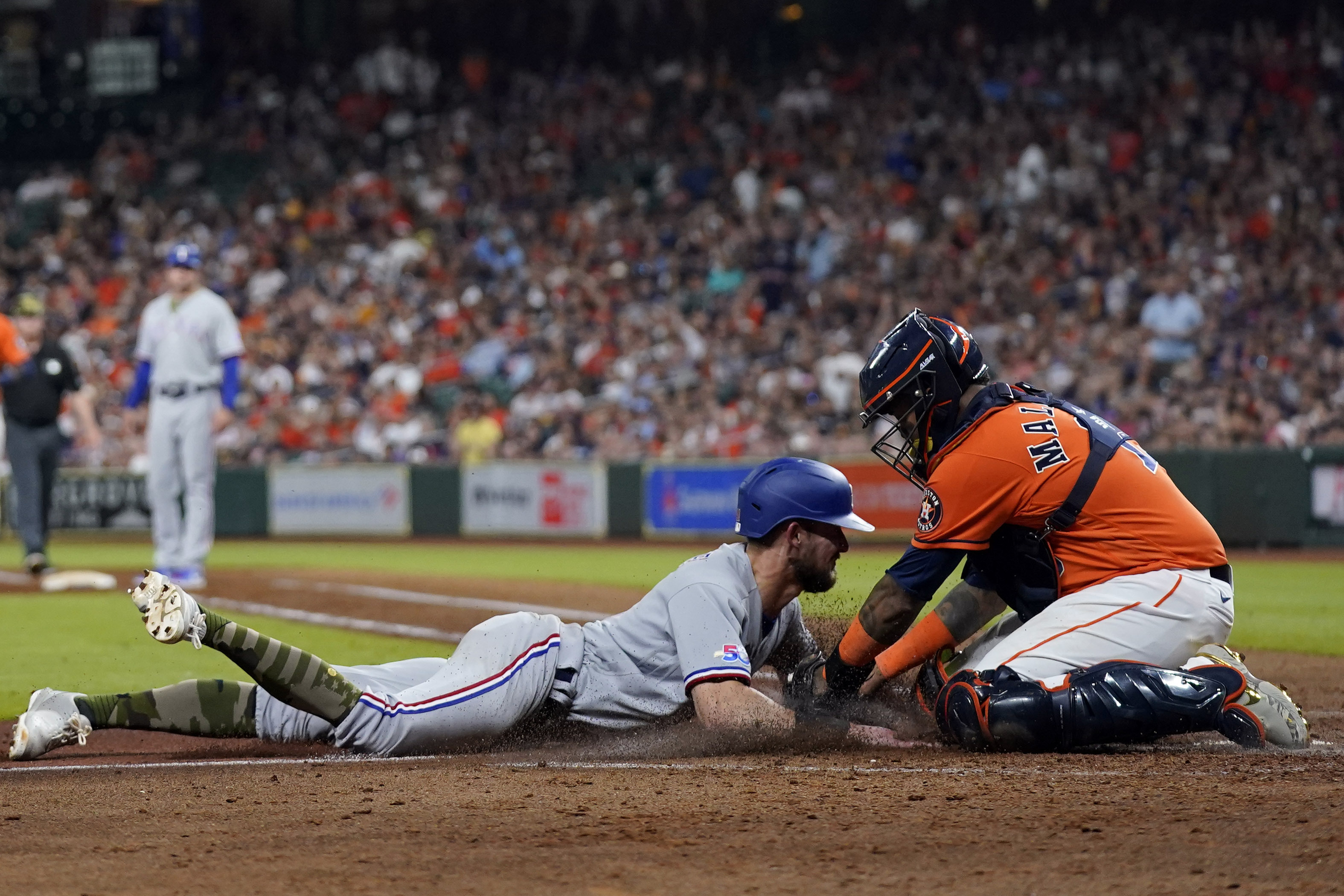 Texas Rangers' Kole Calhoun follows through on a run-scoring