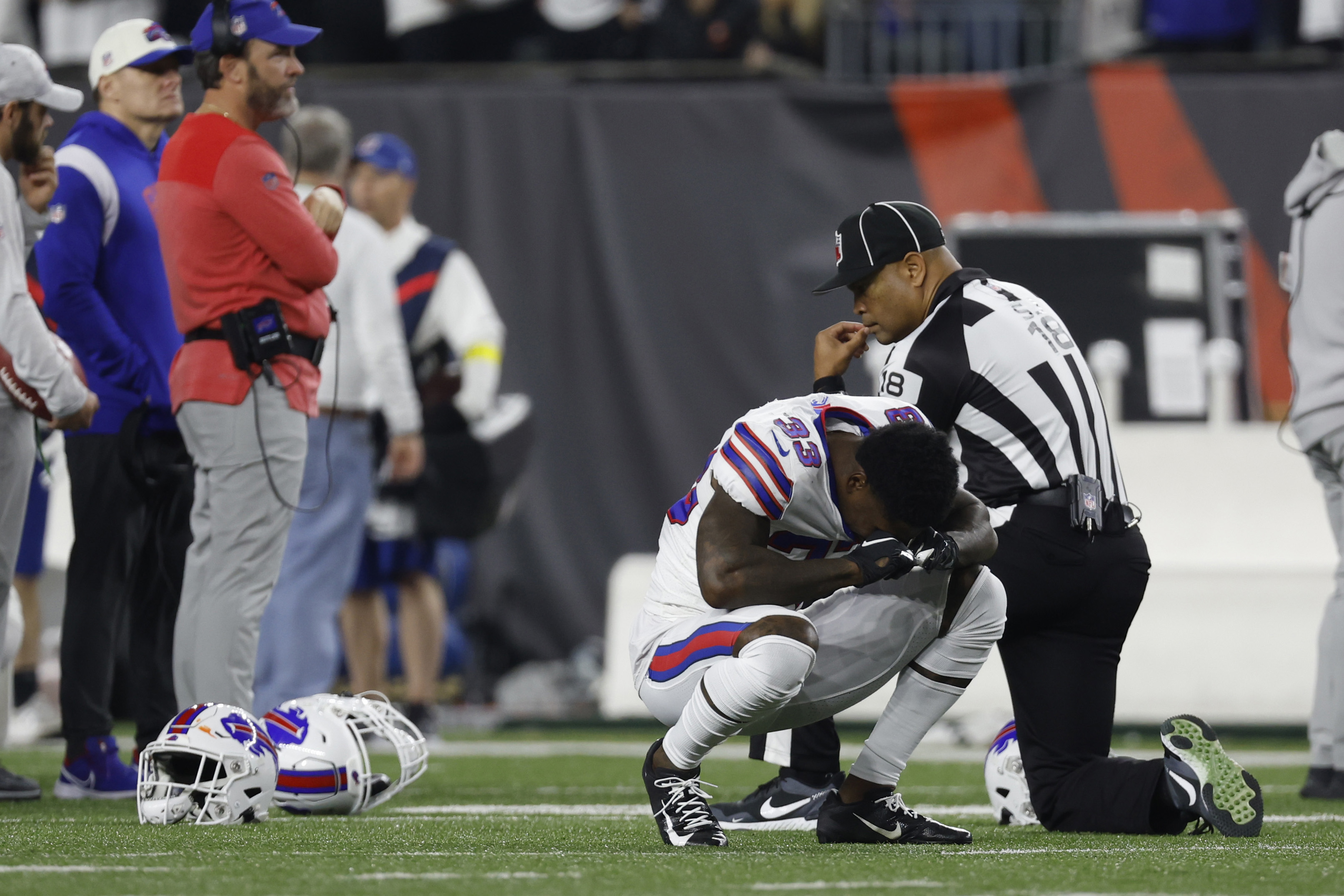 Cincinnati Bengals players kneel as Damar Hamlin is examined