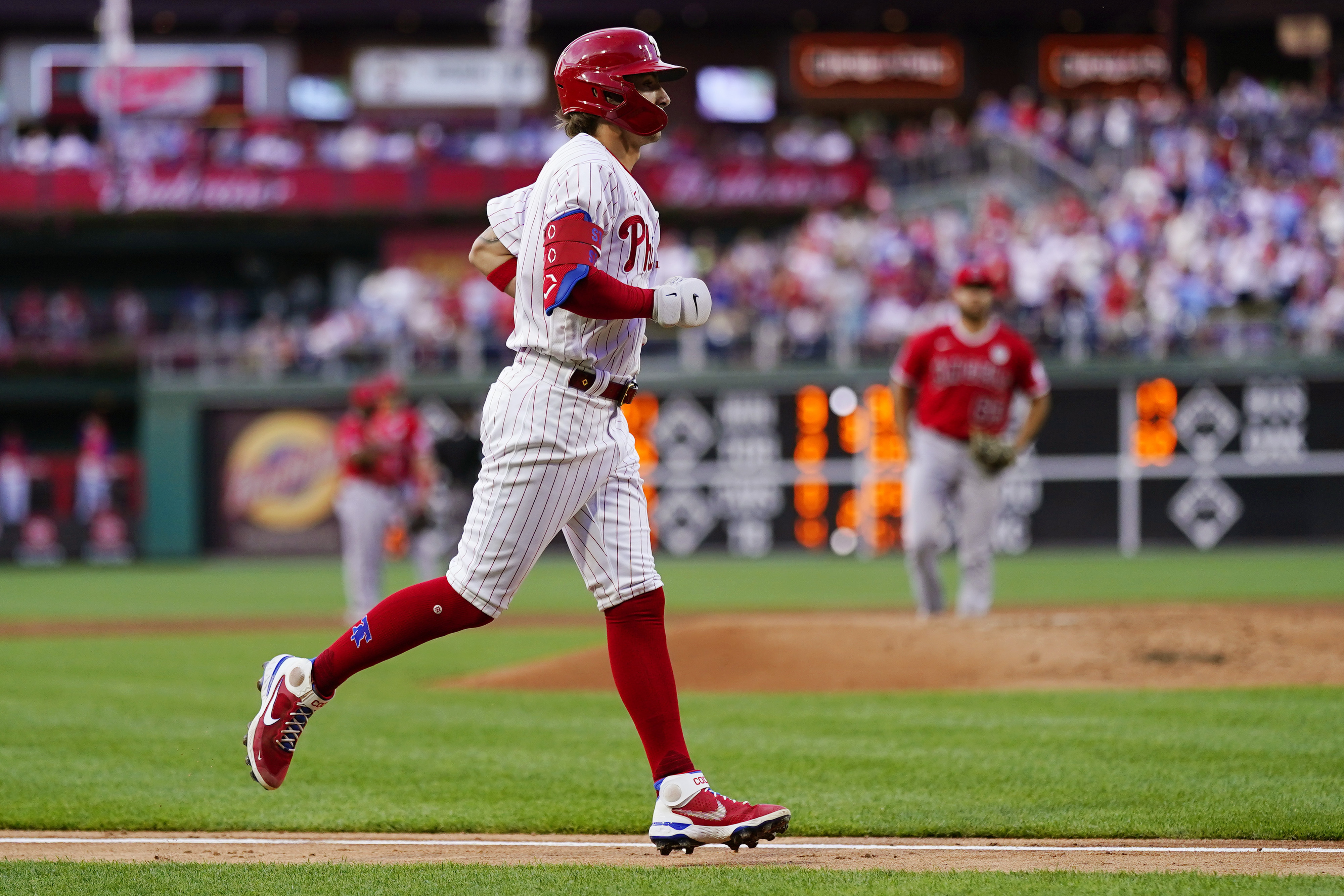 Shohei Ohtani of the Los Angeles Angels puts on pink cleats to