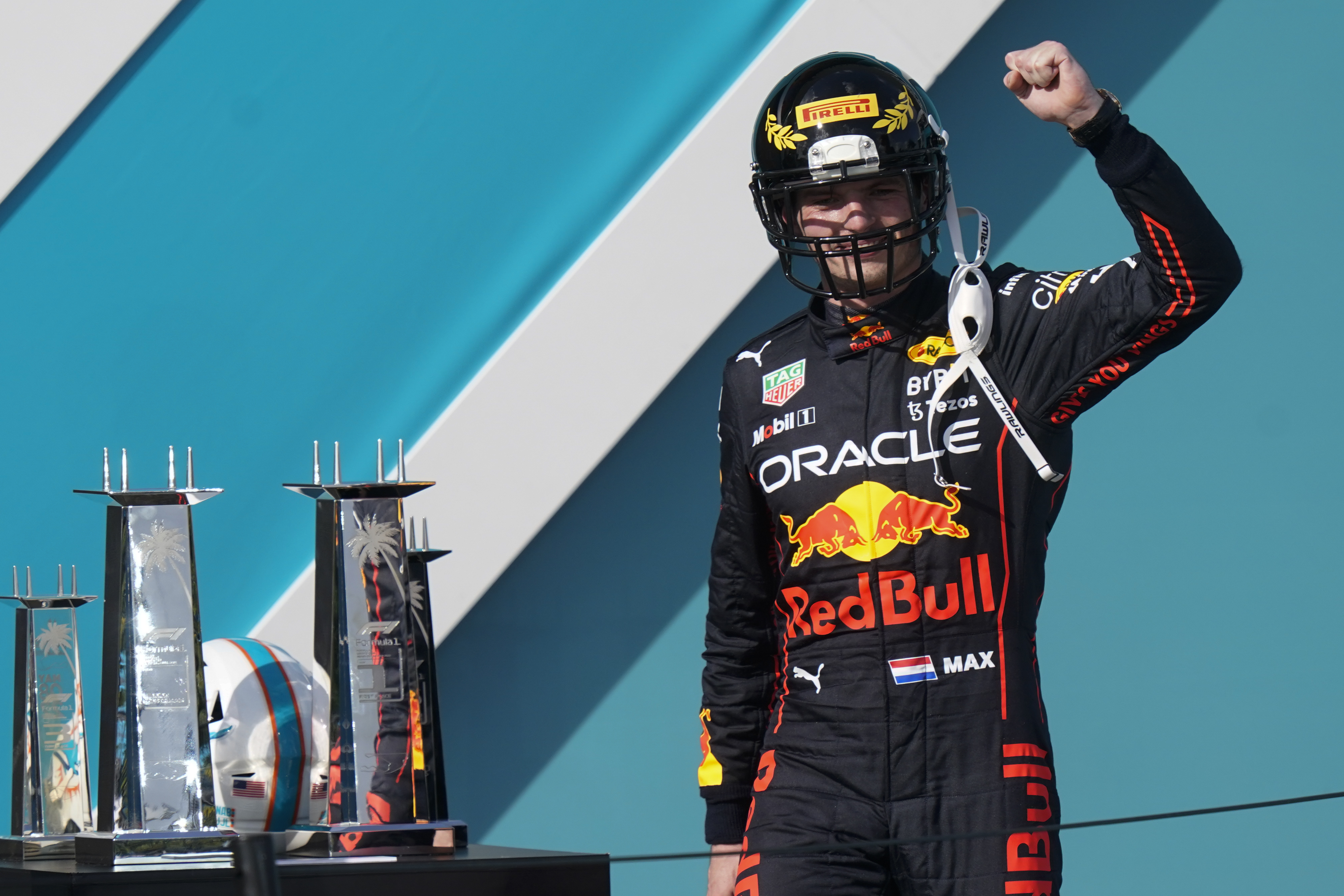 Miami Gardens, Florida, May 8, 2022. Dutch Formula One driver Max  Verstappen of Red Bull Racing holds a Miami Dolphins helmet signed by Dan  Marino and the first place trophy during the