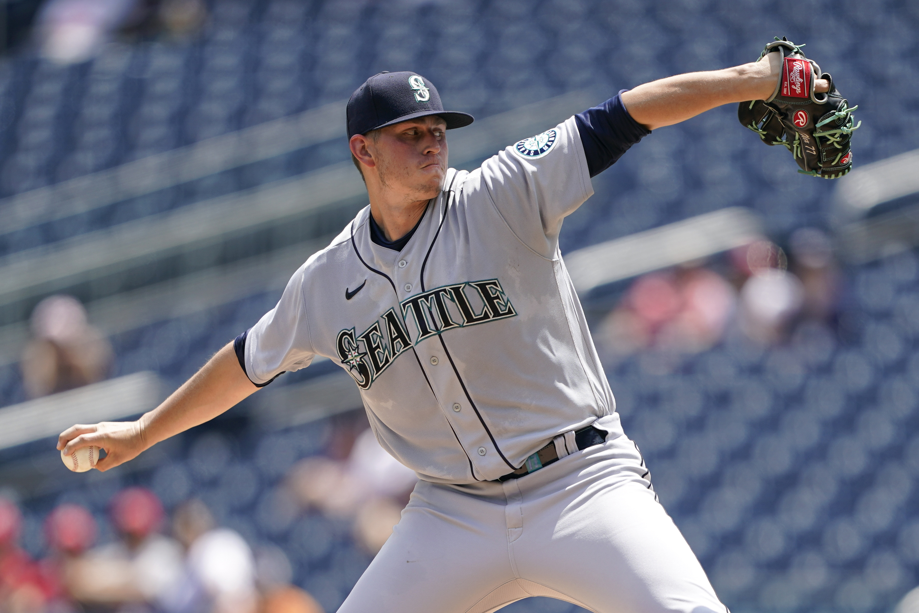 Seattle Mariners catcher Cal Raleigh, left, and relief pitcher Paul Sewald  celebrate after a baseball game