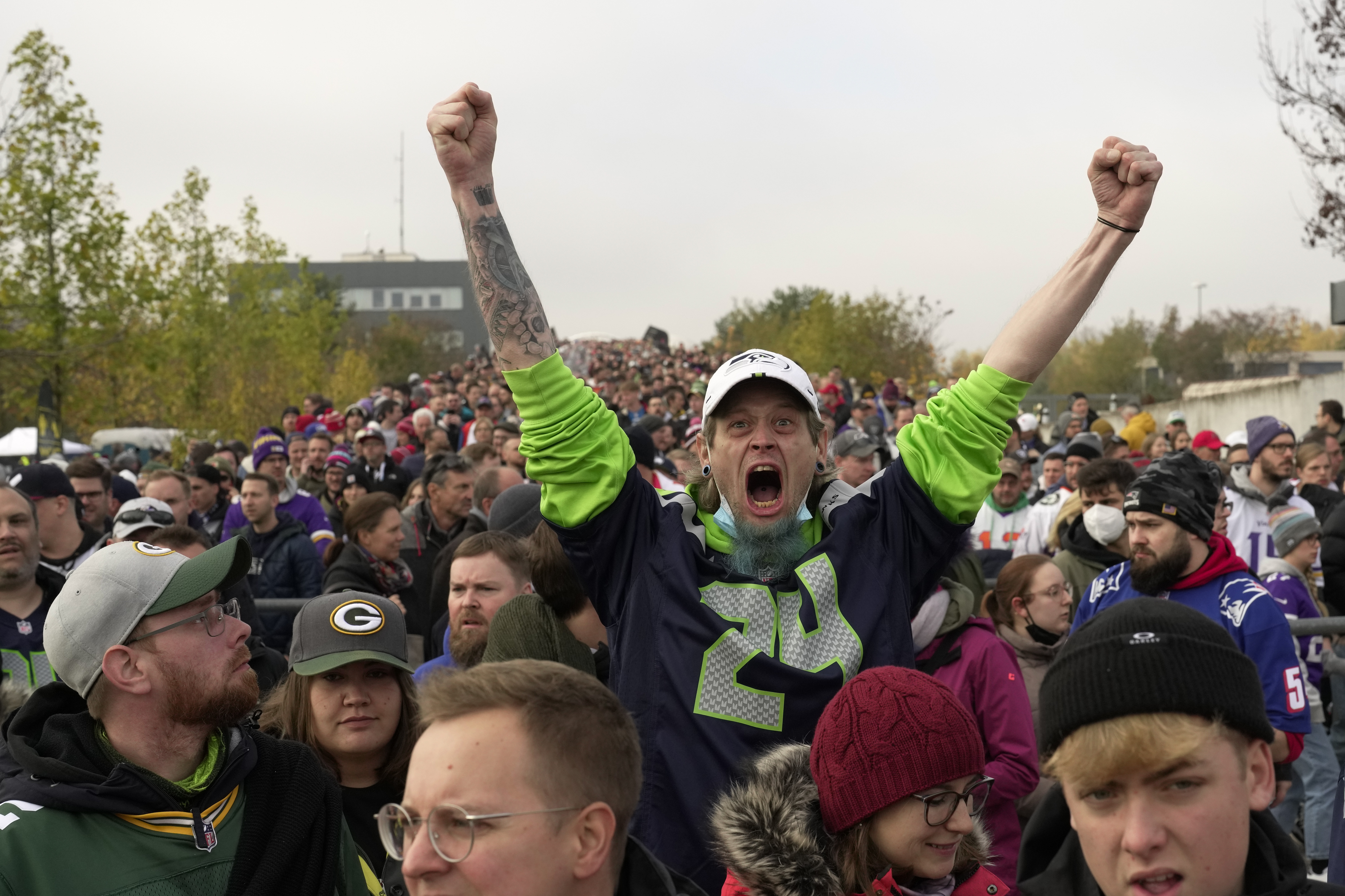 Fans queue up outside the NFL Shop before an NFL football game between the  Tampa Bay Buccaneers and the Seattle Seahawks at Allianz Arena in Munich,  Germany, Sunday, Nov. 13, 2022. (AP