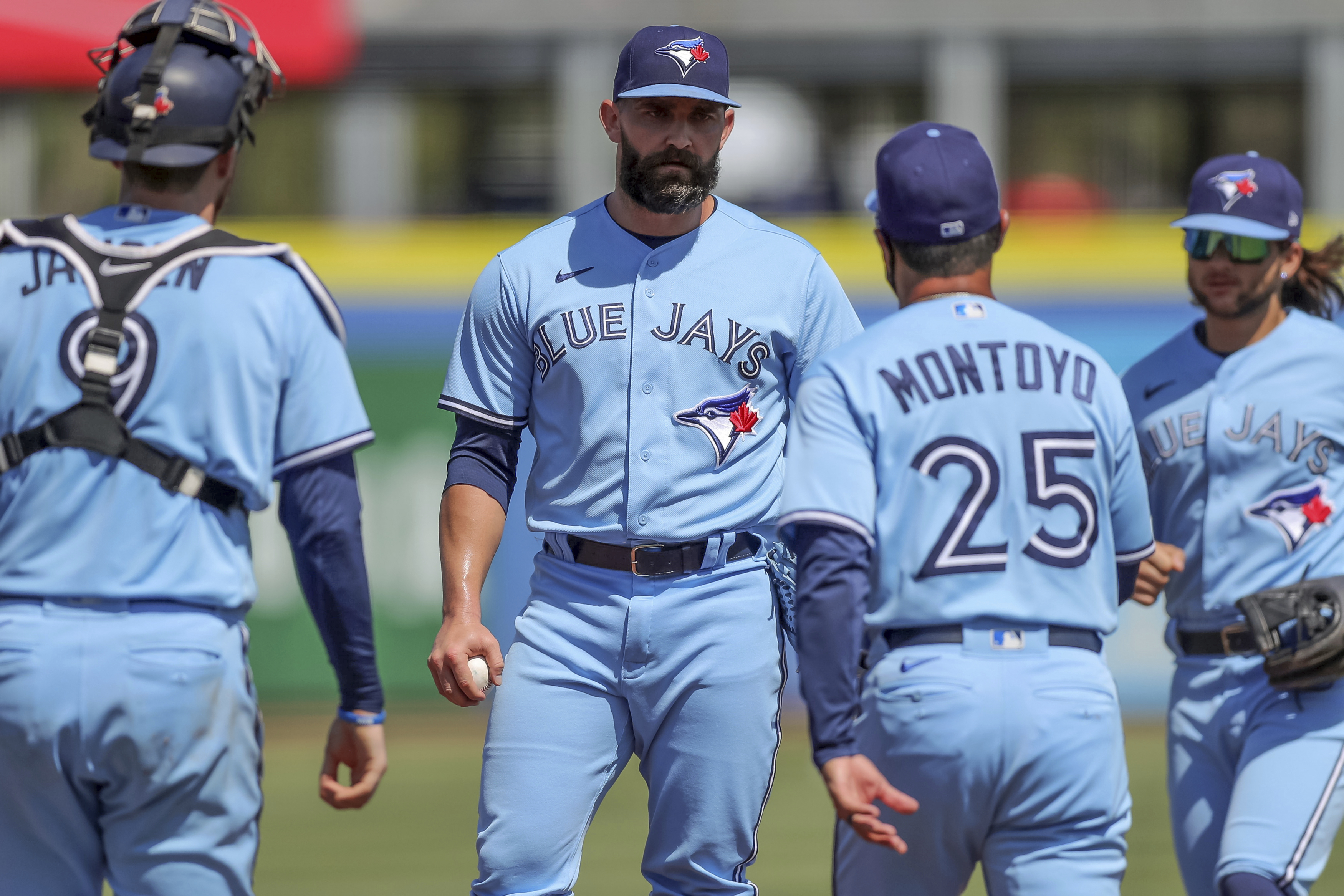 Toronto Blue Jays catcher Danny Jansen (9) gives a forearm bump to