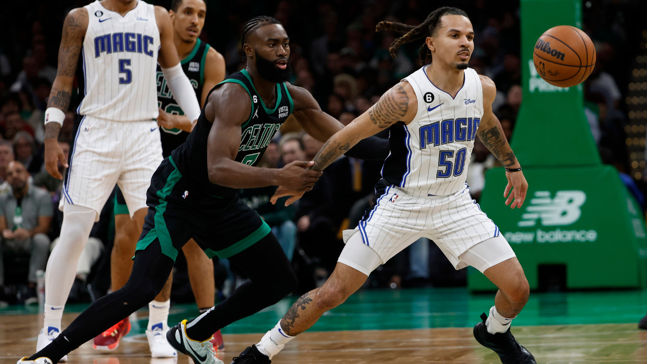 magic wearing celtics shirt