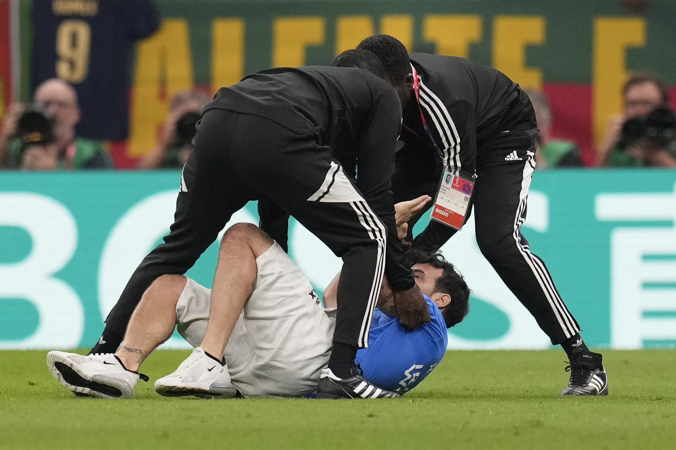 Doha, Qatar. 28th Nov, 2022. Streaker runs with rainbow flag and Superman  Save Ukraine Shirt over the playing field. and is stopped by security  Portugal - Uruguay Deutschland - Spanien World Cup