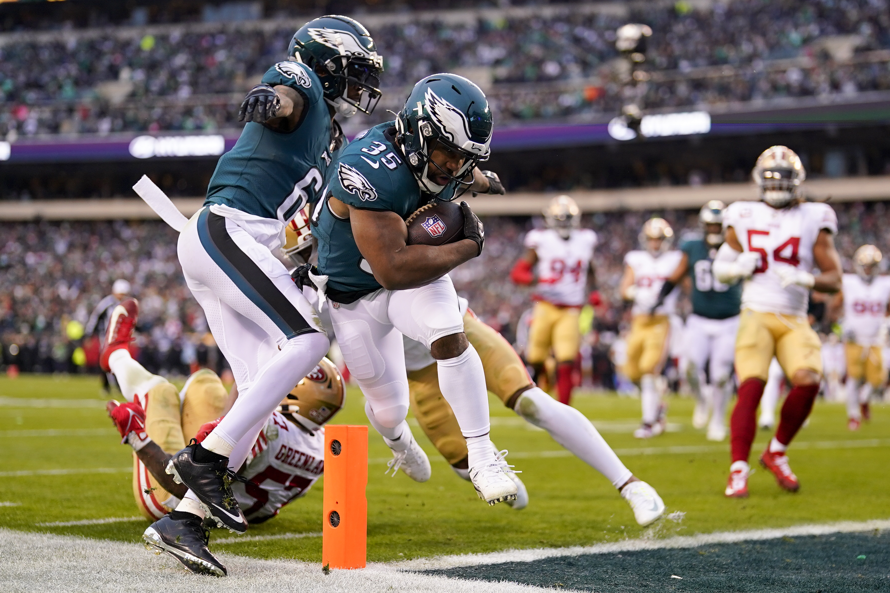 Jalen Hurts of the Philadelphia Eagles holds the George Halas