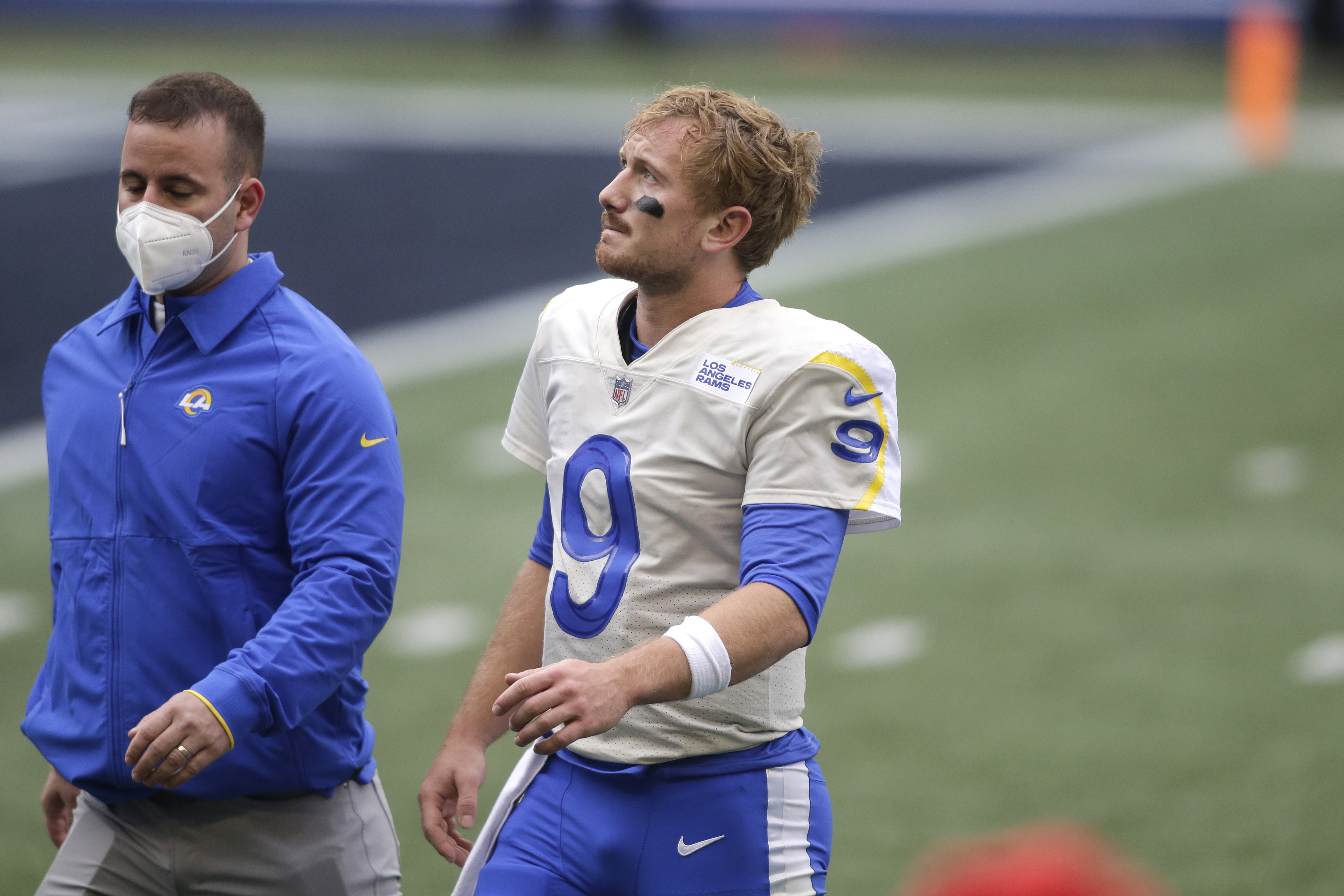 Los Angeles Rams head coach Sean McVay talks to quarterback John Wolford (13)  before an NFL