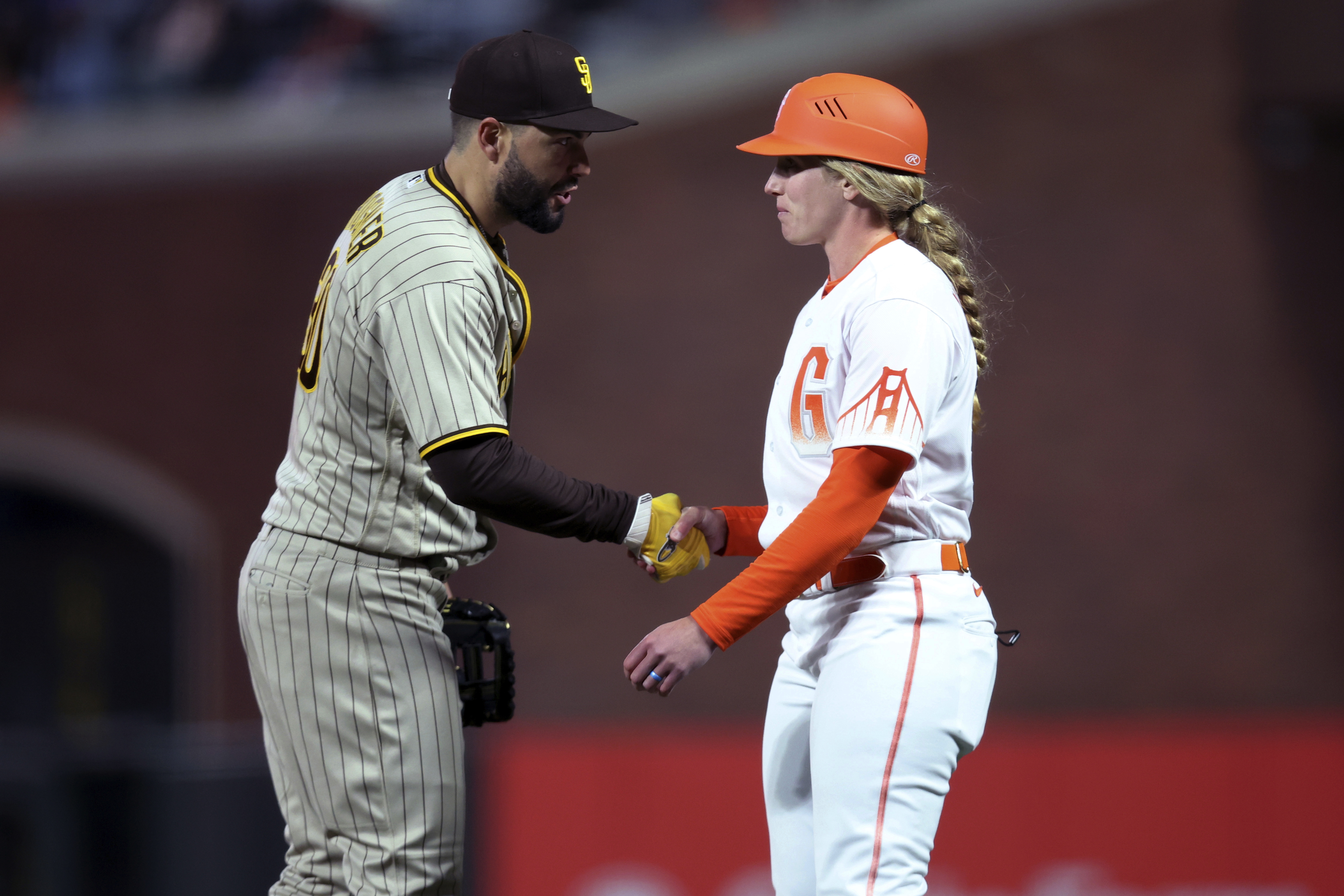 San Francisco Giants' Logan Webb wears a hat and shirt for first baseman Brandon  Belt before a baseball game between the Giants and the Arizona Diamondbacks  in San Francisco, Wednesday, Sept. 29