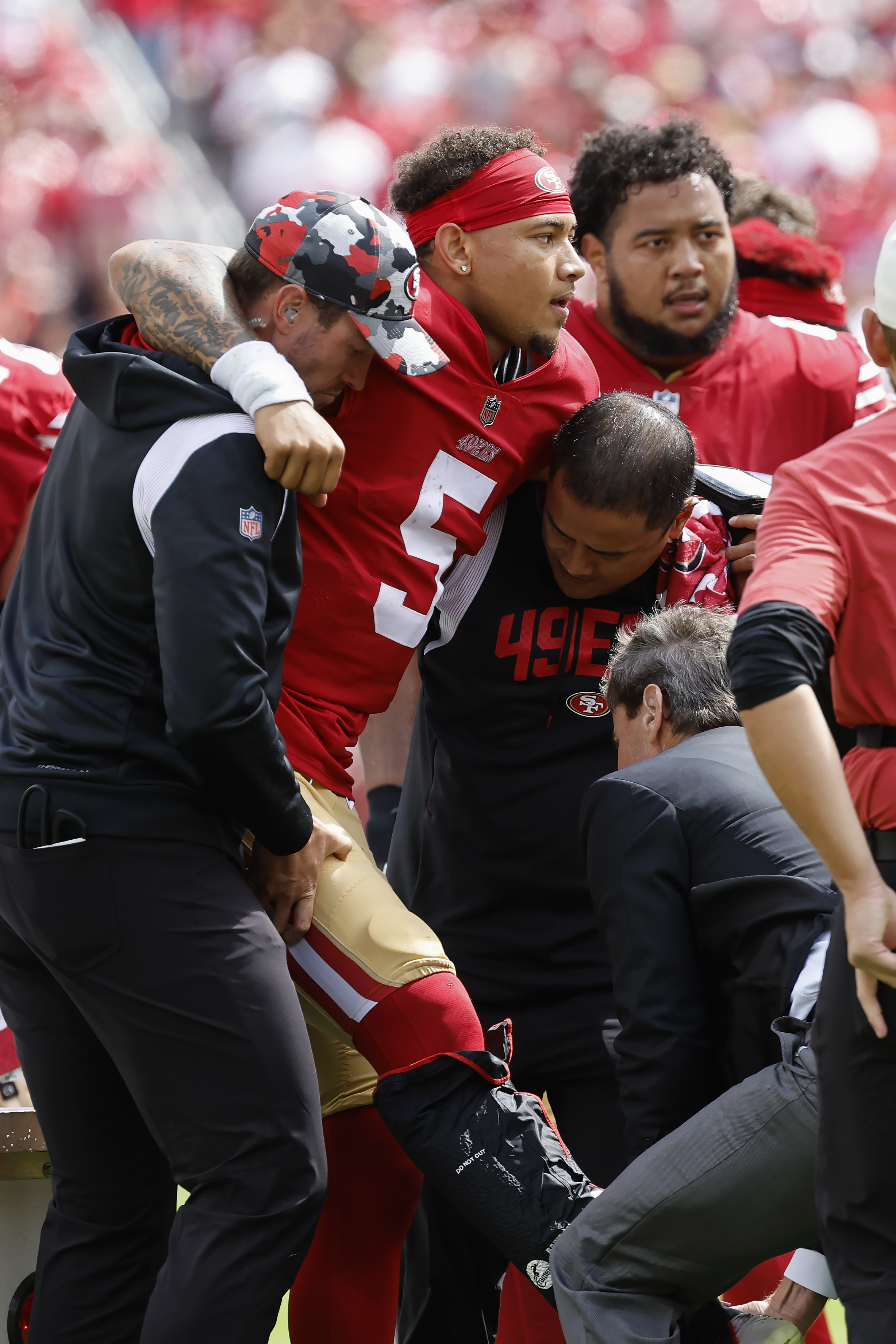 Quarterback Trey Lance of the San Francisco 49ers escapes a sack