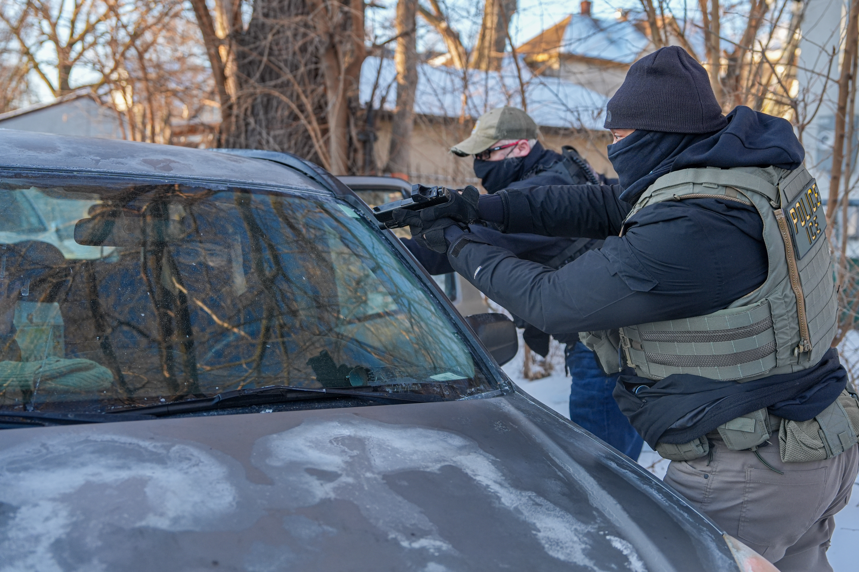 Immigration agents draw guns and arrest activists following them