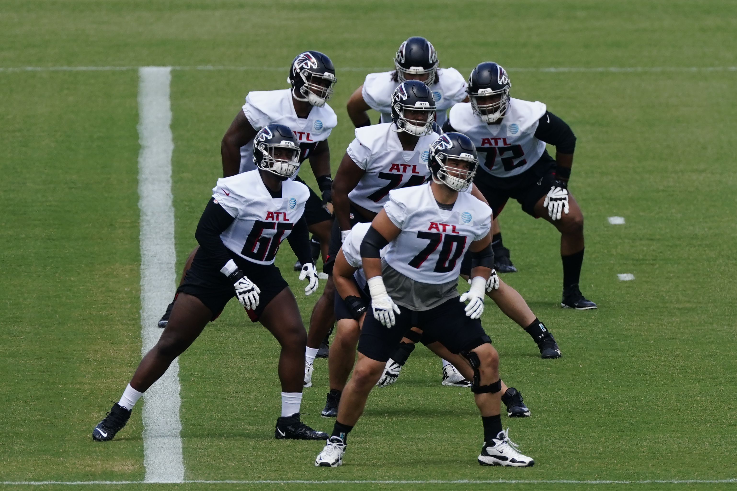 Atlanta Falcons guard Chris Lindstrom (63) and tight ends coach