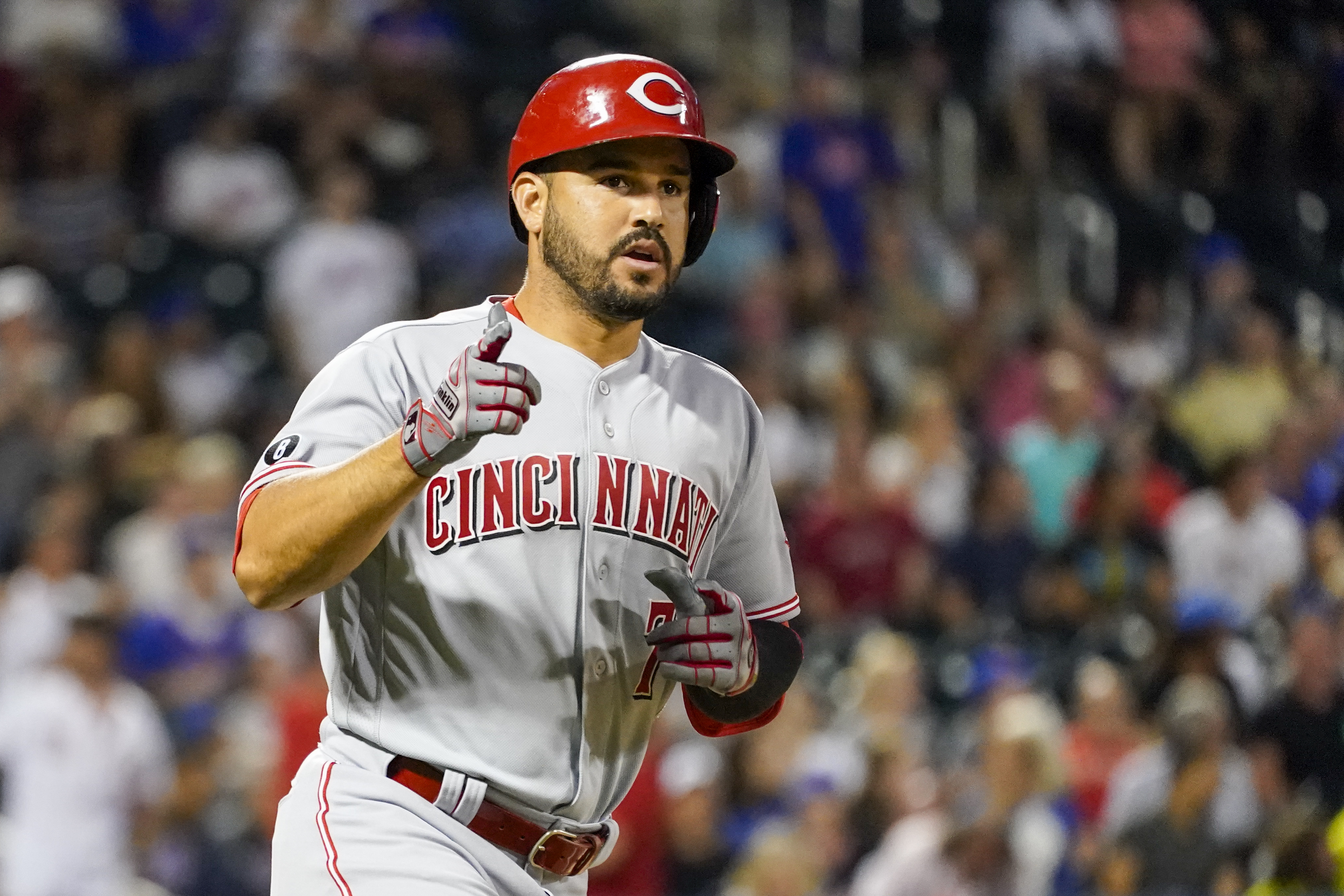 Seattle Mariners' Eugenio Suarez blows a bubble in the dugout