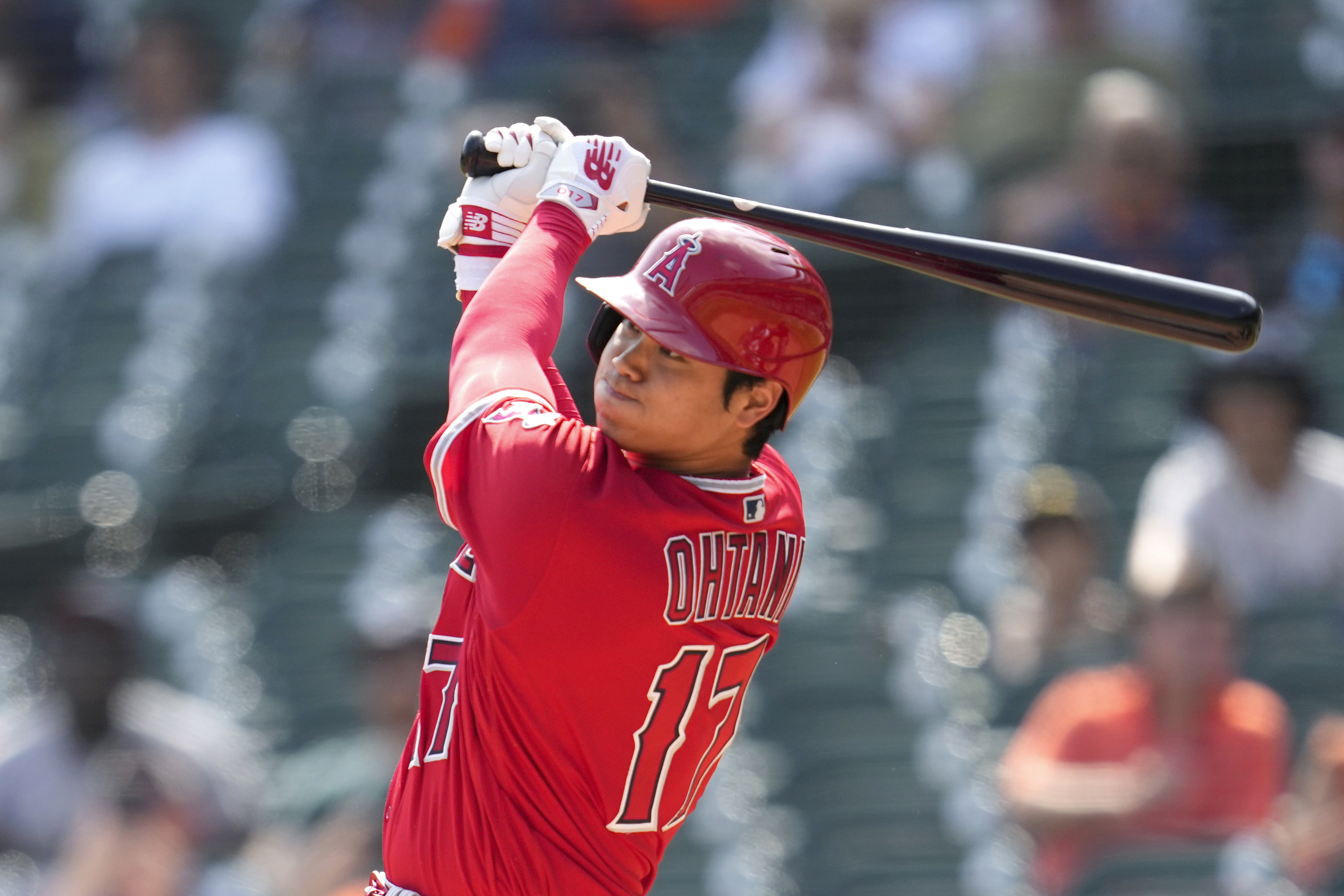 Shohei Ohtani of the Los Angeles Angels celebrates wearing a samurai  warrior helmet in the dugout after hitting a two-run home run in the third  inning of a baseball game against the