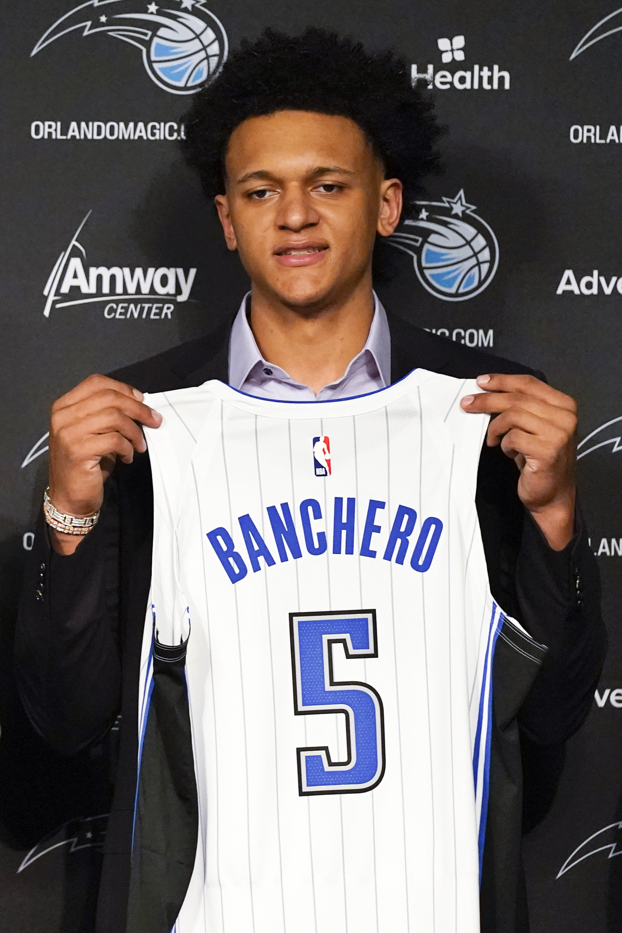 Orlando Magic draft picks forward Caleb Houstan (2) and forward Paolo  Banchero (5) show off their new jerseys during a news conference for the  NBA basketball team, Friday, June 24, 2022, in