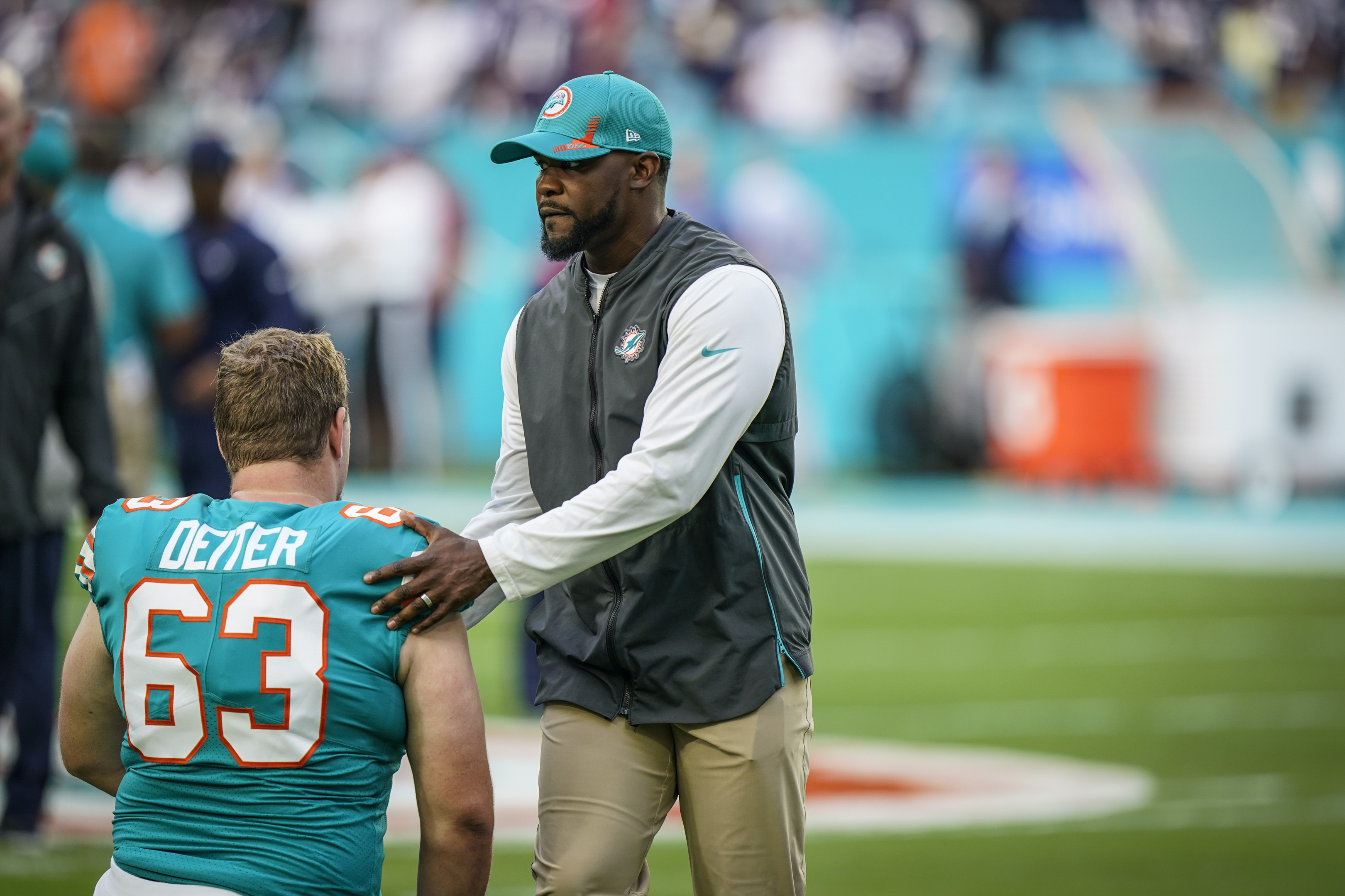 Miami Dolphins guard Michael Deiter (63) carries a football as he