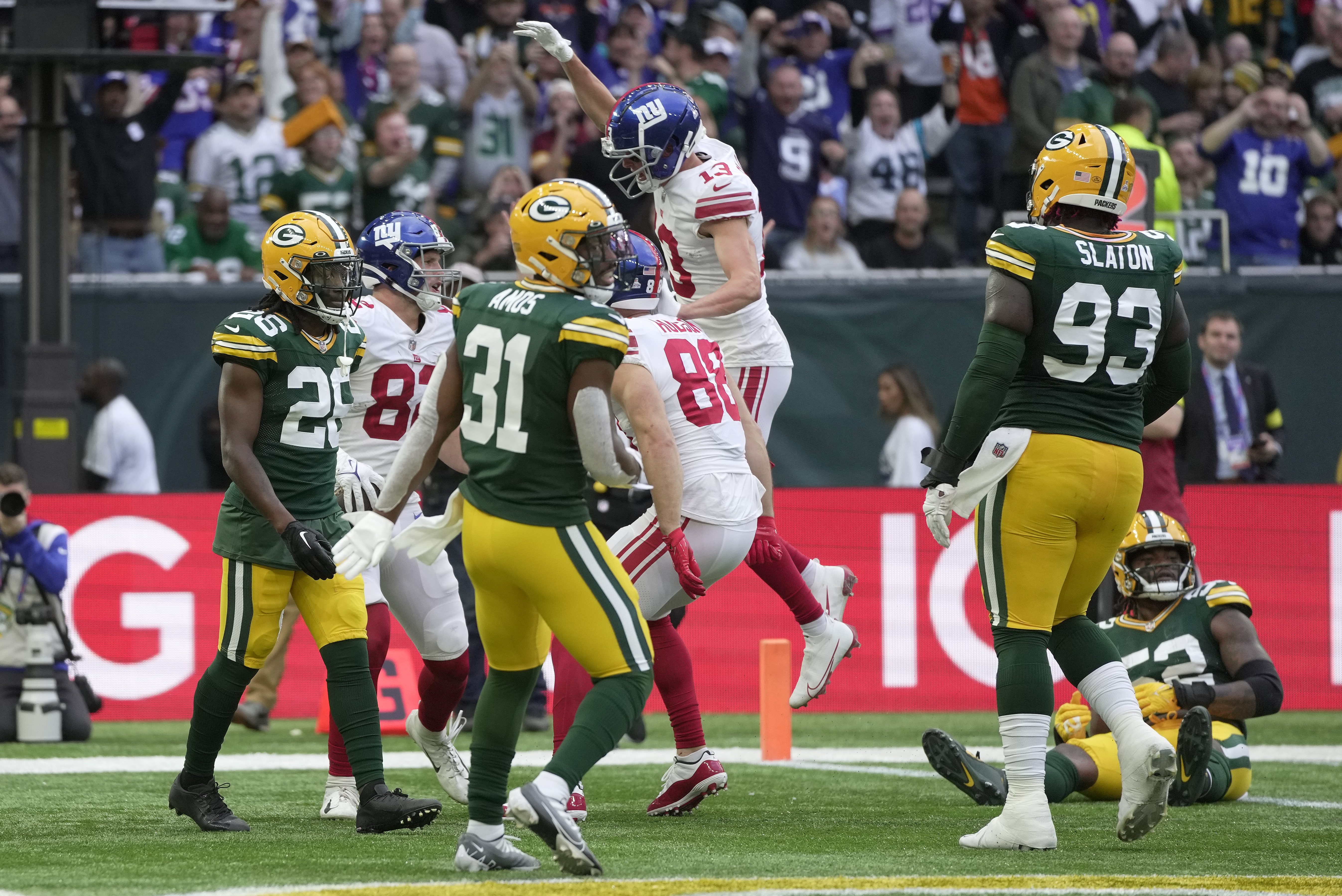 Green Bay Packers linebacker Rashan Gary (52) and defensive back Darnell  Savage (26) set up for a play during the first half of an NFL football game  against the New Orleans Saints