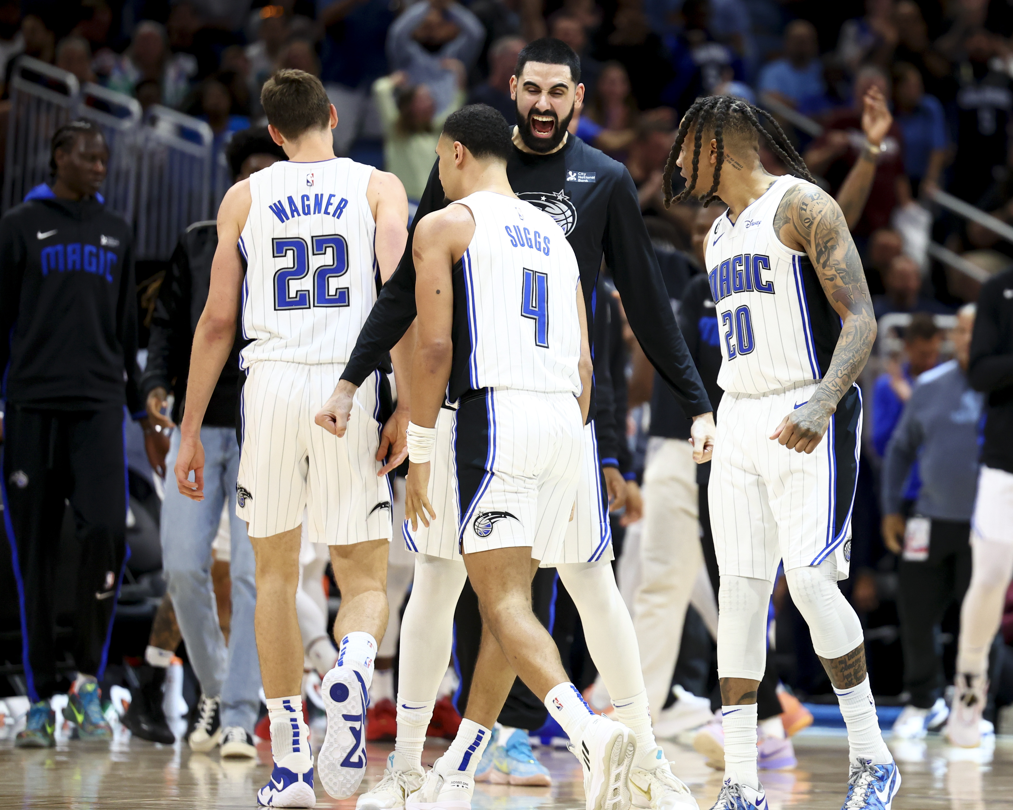 Orlando Magic's Jalen Suggs (4) takes a shot over Cleveland Cavaliers' Dean  Wade, left, during the