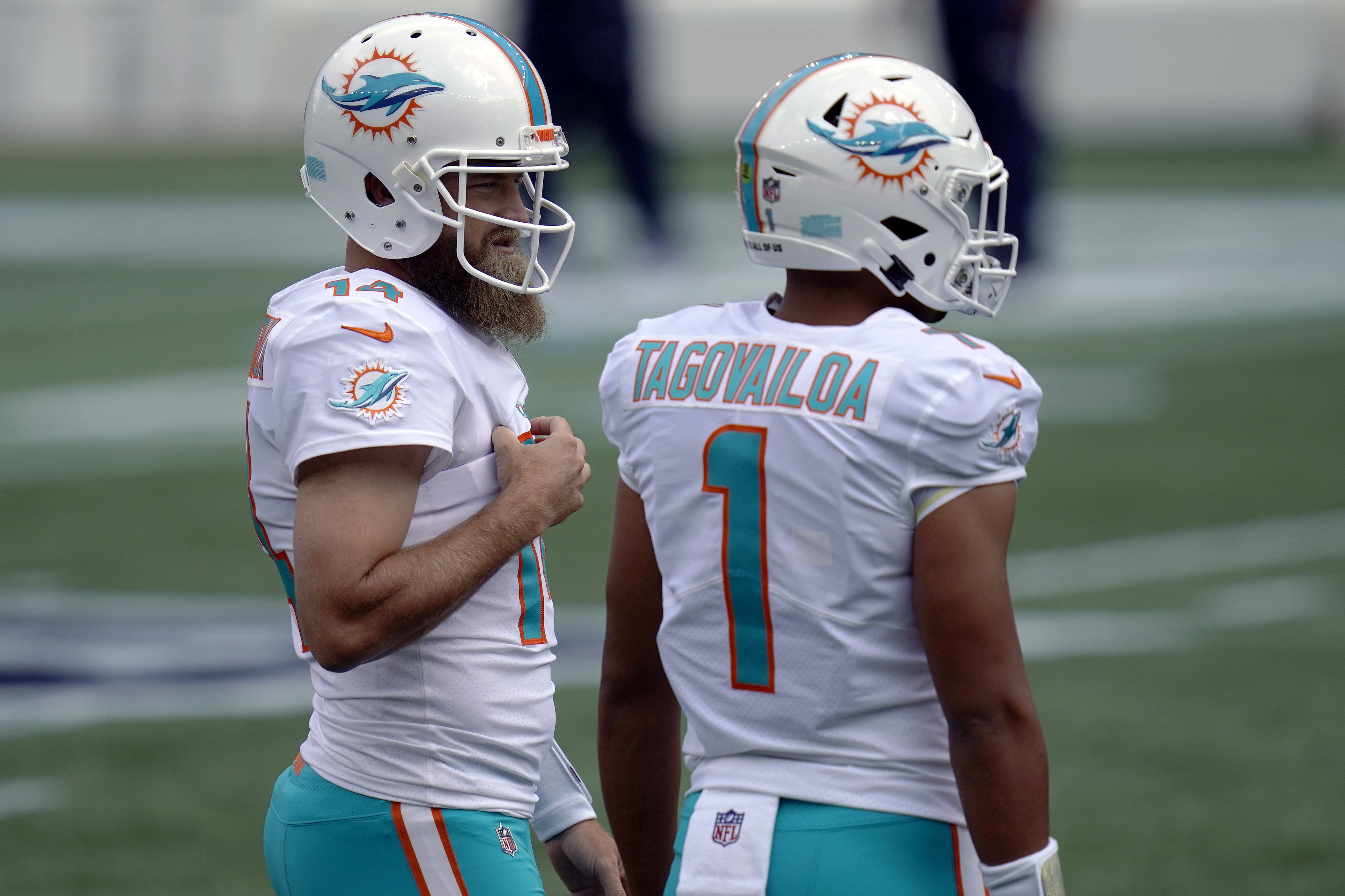 Miami Dolphins quarterback Tua Tagovailoa (1) warms up before an