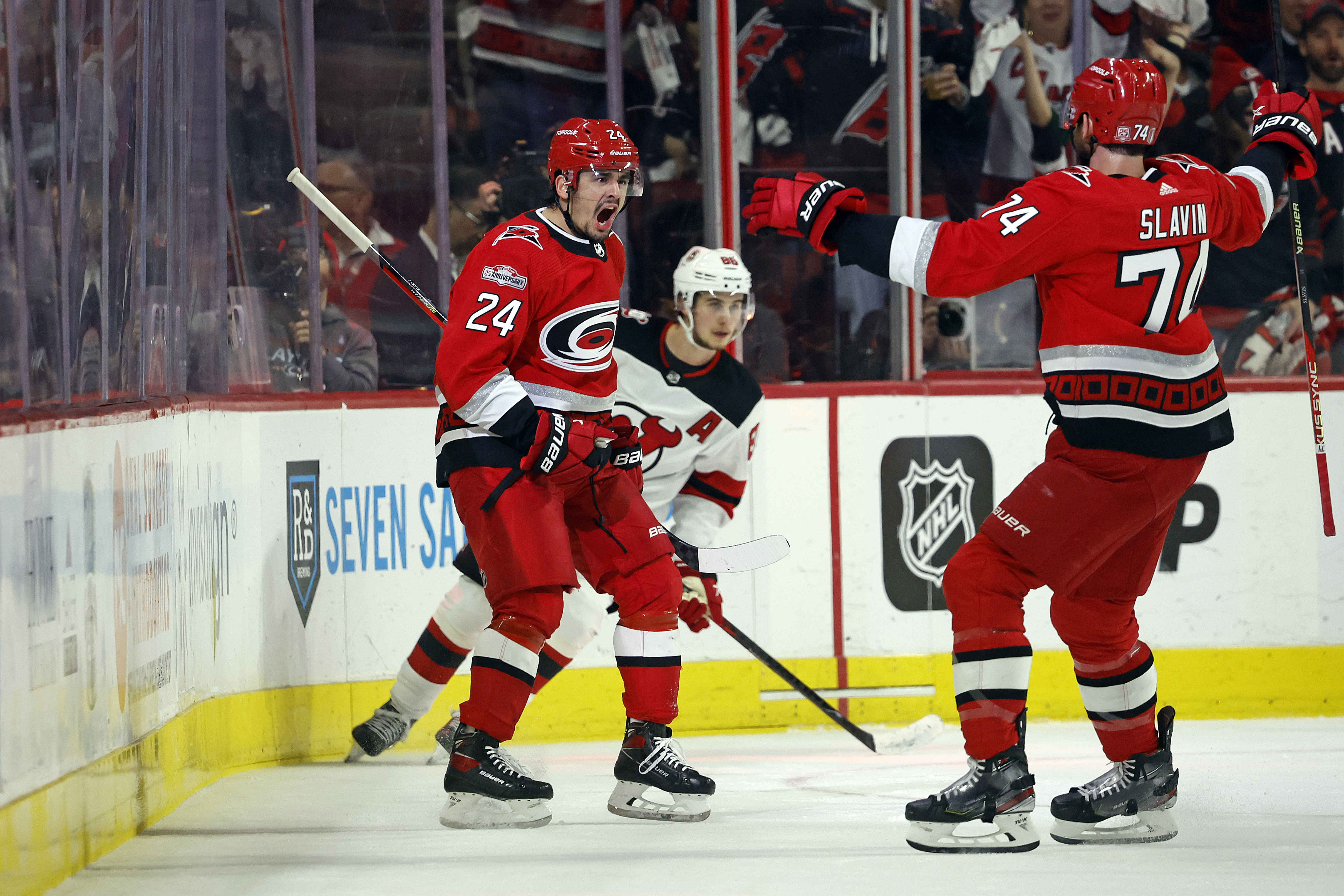 Carolina Hurricanes defenseman Brent Burns (8) celebrates with Frederik  Andersen (31) after the Hurricanes defeated the New Jersey Devils in Game 4  of an NHL hockey Stanley Cup second-round playoff series Tuesday