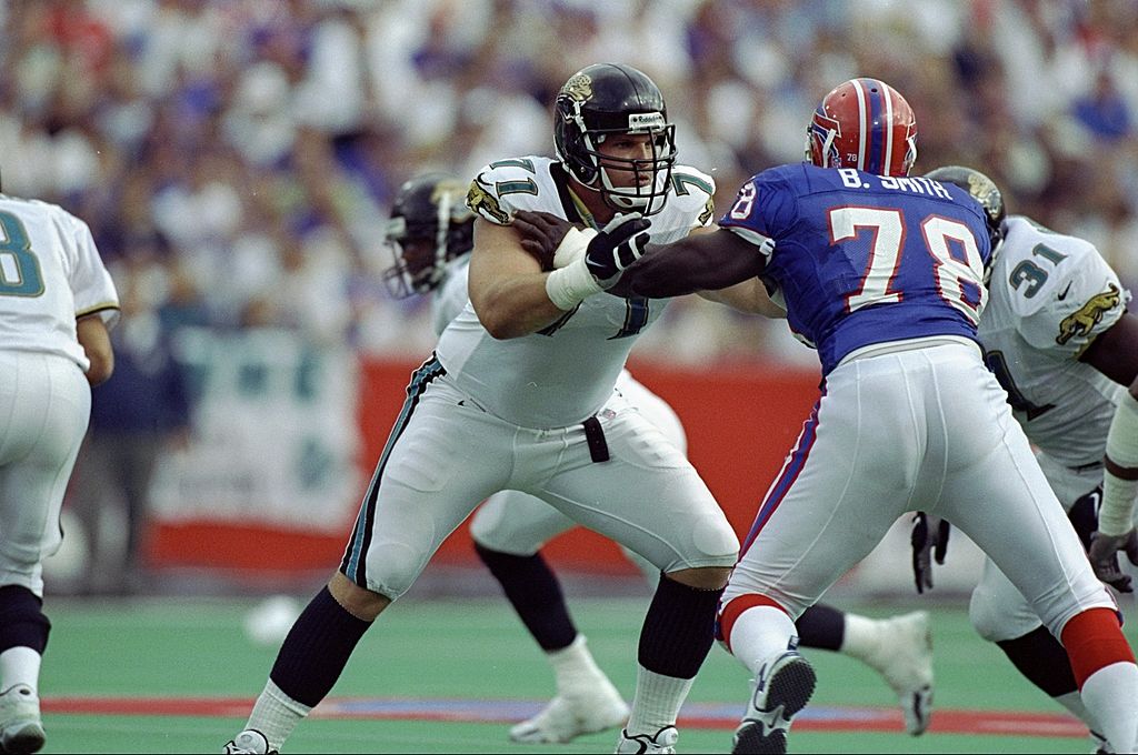 Tony Brackens of the Jacksonville Jaguars stands on the field