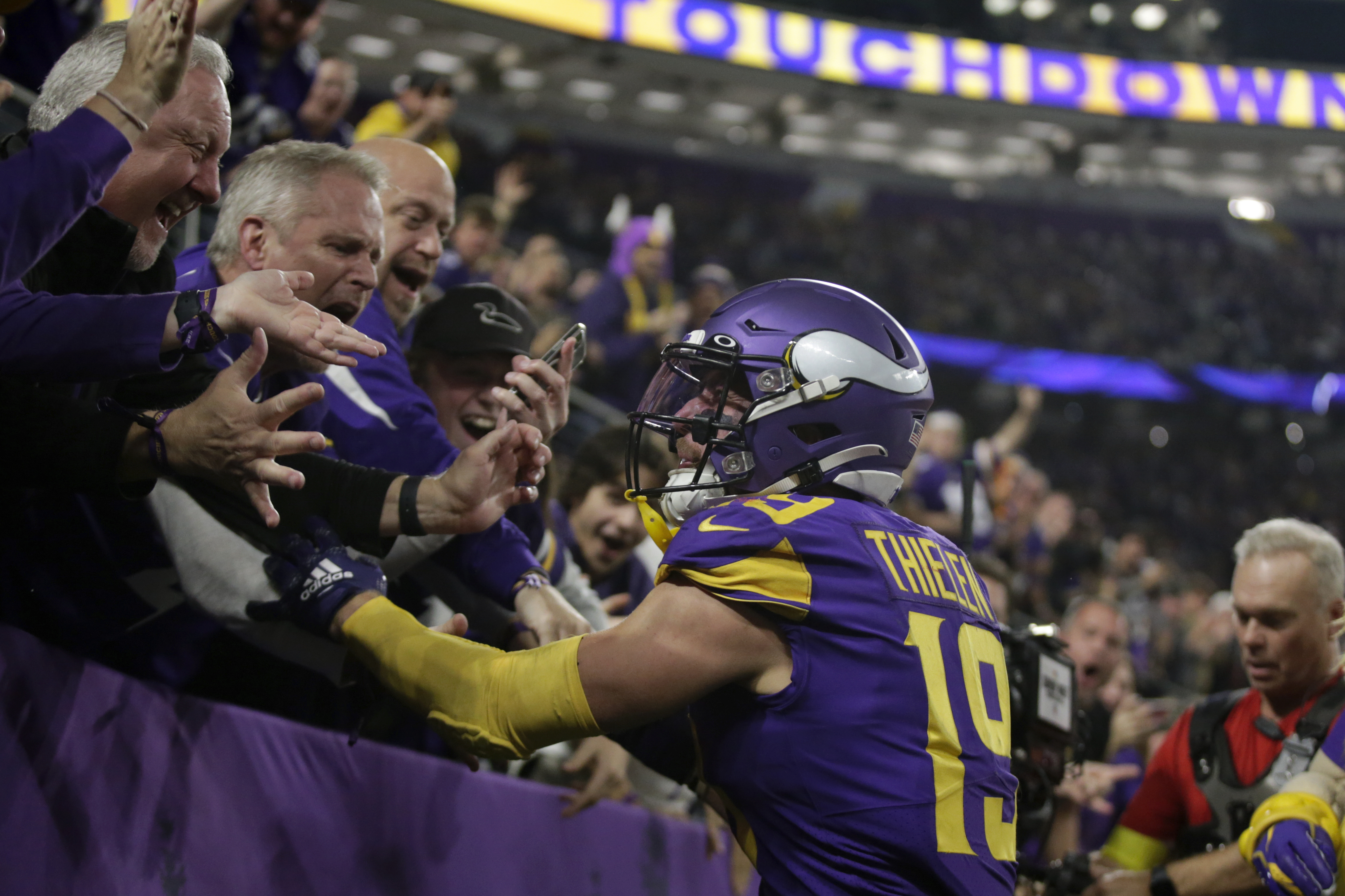 Minnesota Vikings wide receivers Justin Jefferson (18) and Adam Thielen  (19) celebrate after Jefferson scored a touchdown against the New York  Jets, during the second half of an NFL football game Sunday