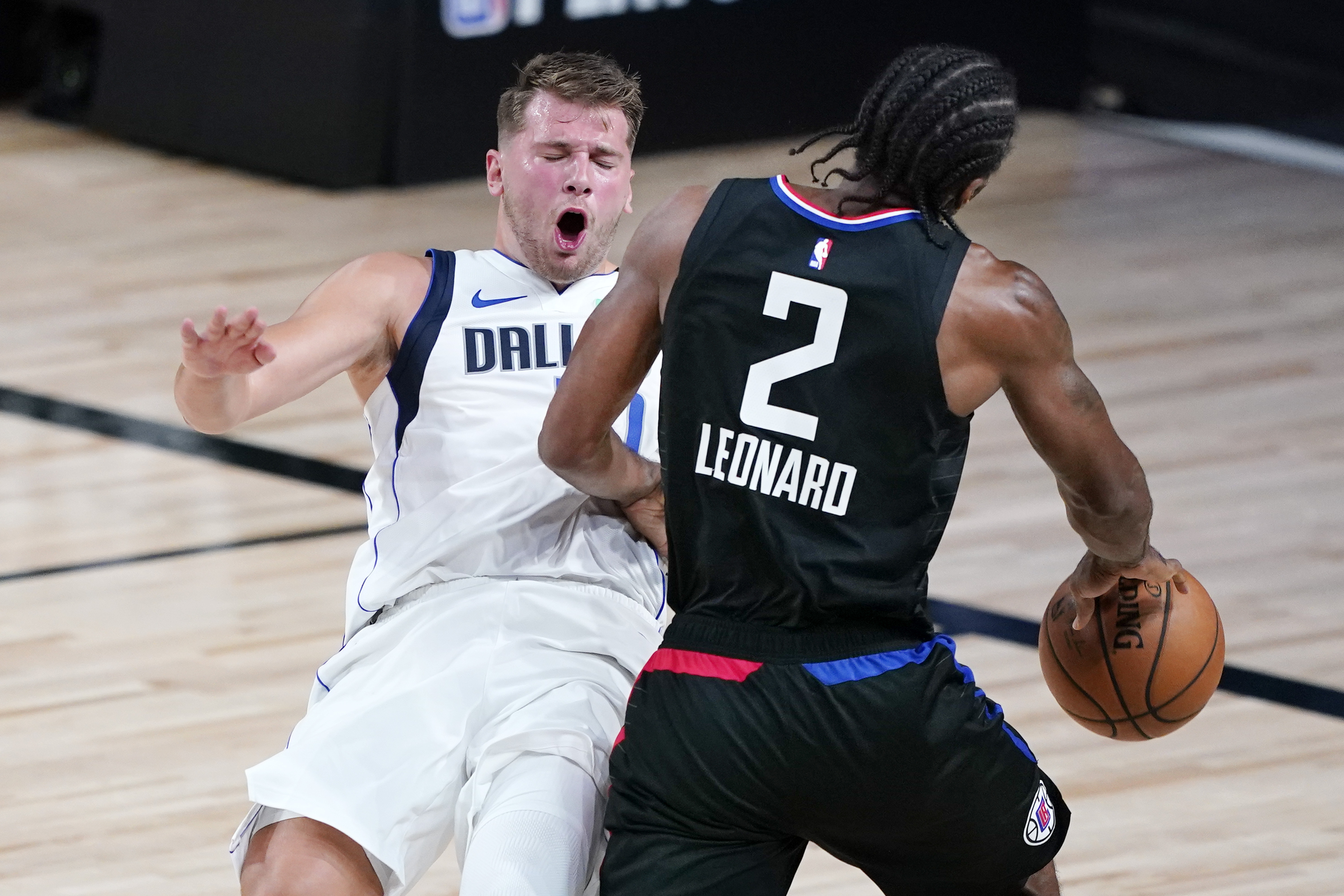 Boban Marjanovic and Luka Doncic of the Dallas Mavericks shake