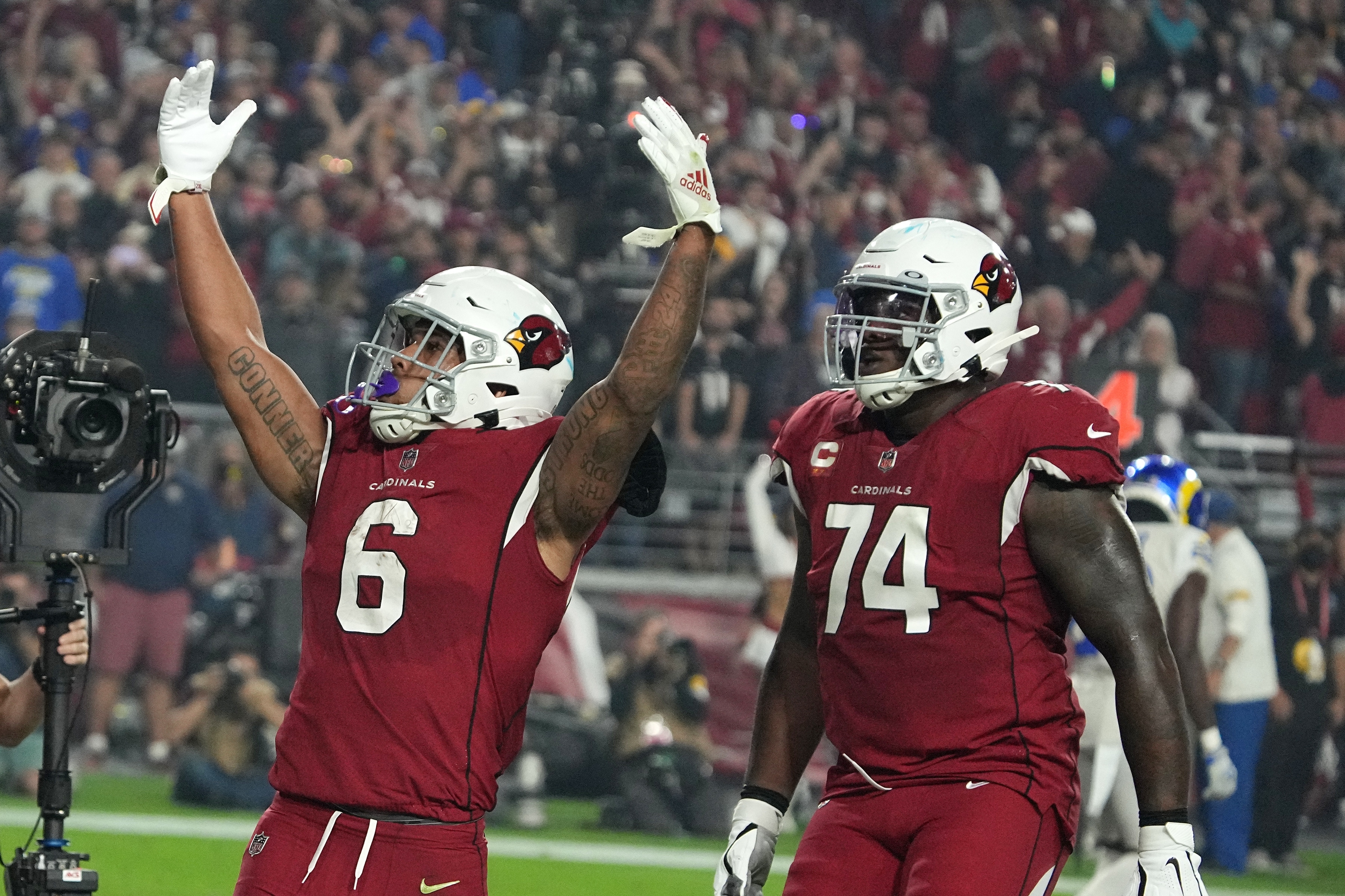 Arizona Cardinals running back James Conner, top, scores a