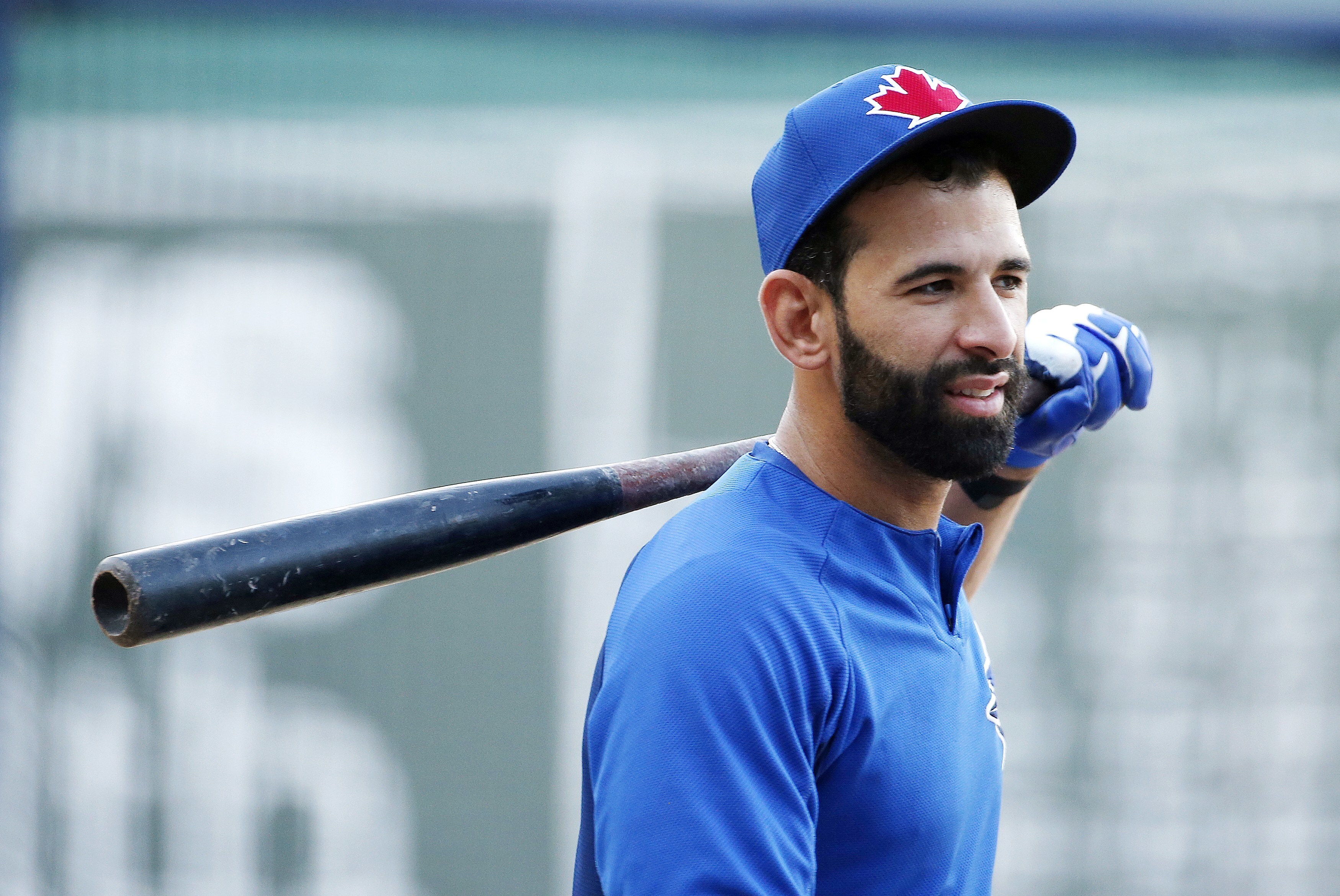 Former Toronto Blue Jays player Jose Bautista, left, signs a fan's jersey  before the Jays take on the Chicago Cubs in Toronto, Friday, Aug. 11 2023.  The Jays will honor Bautista's legacy
