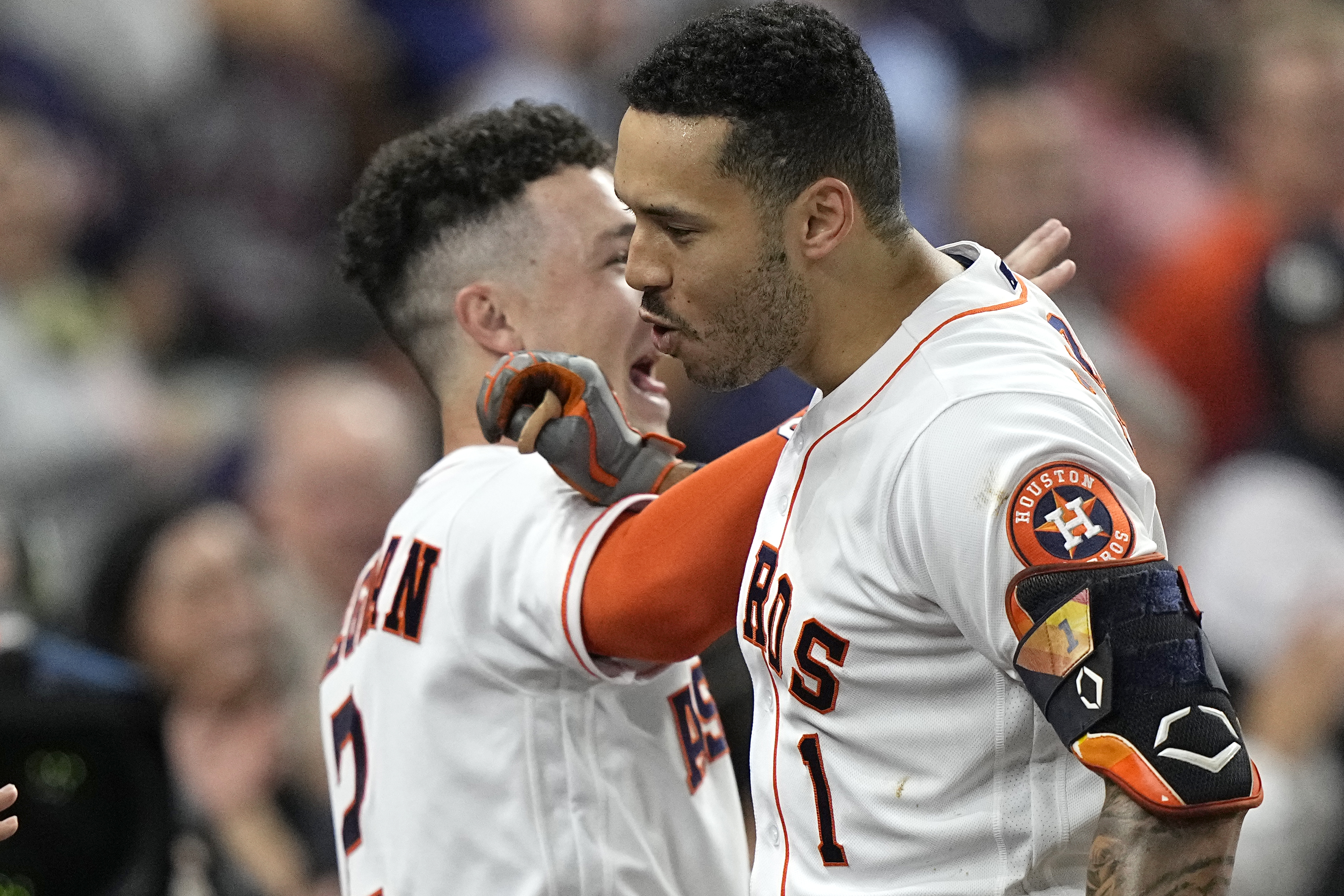 Houston Astros mascot Orbit celebrates by waving a flag that says