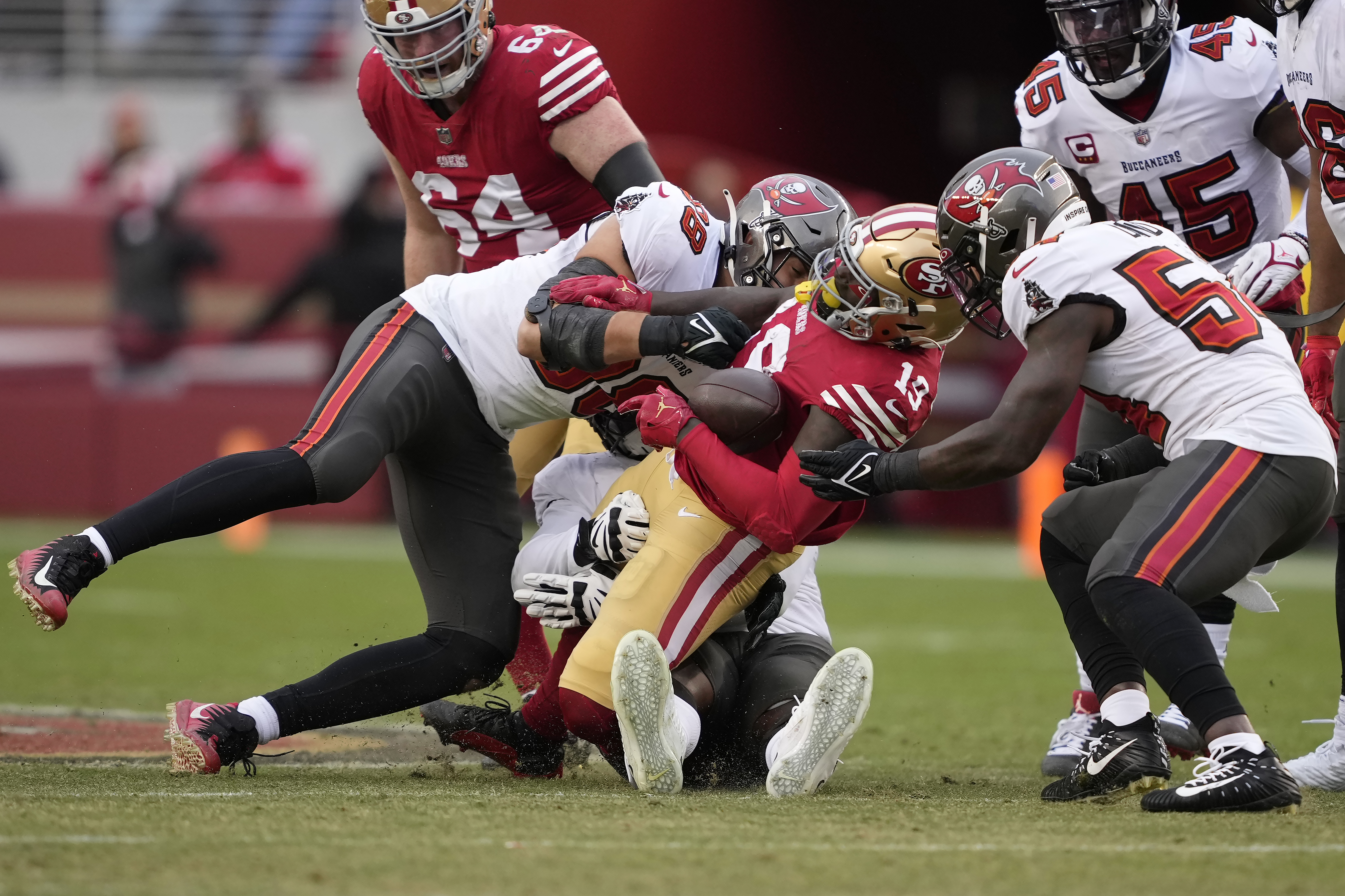 San Francisco 49ers wide receiver Deebo Samuel, left, is tackled