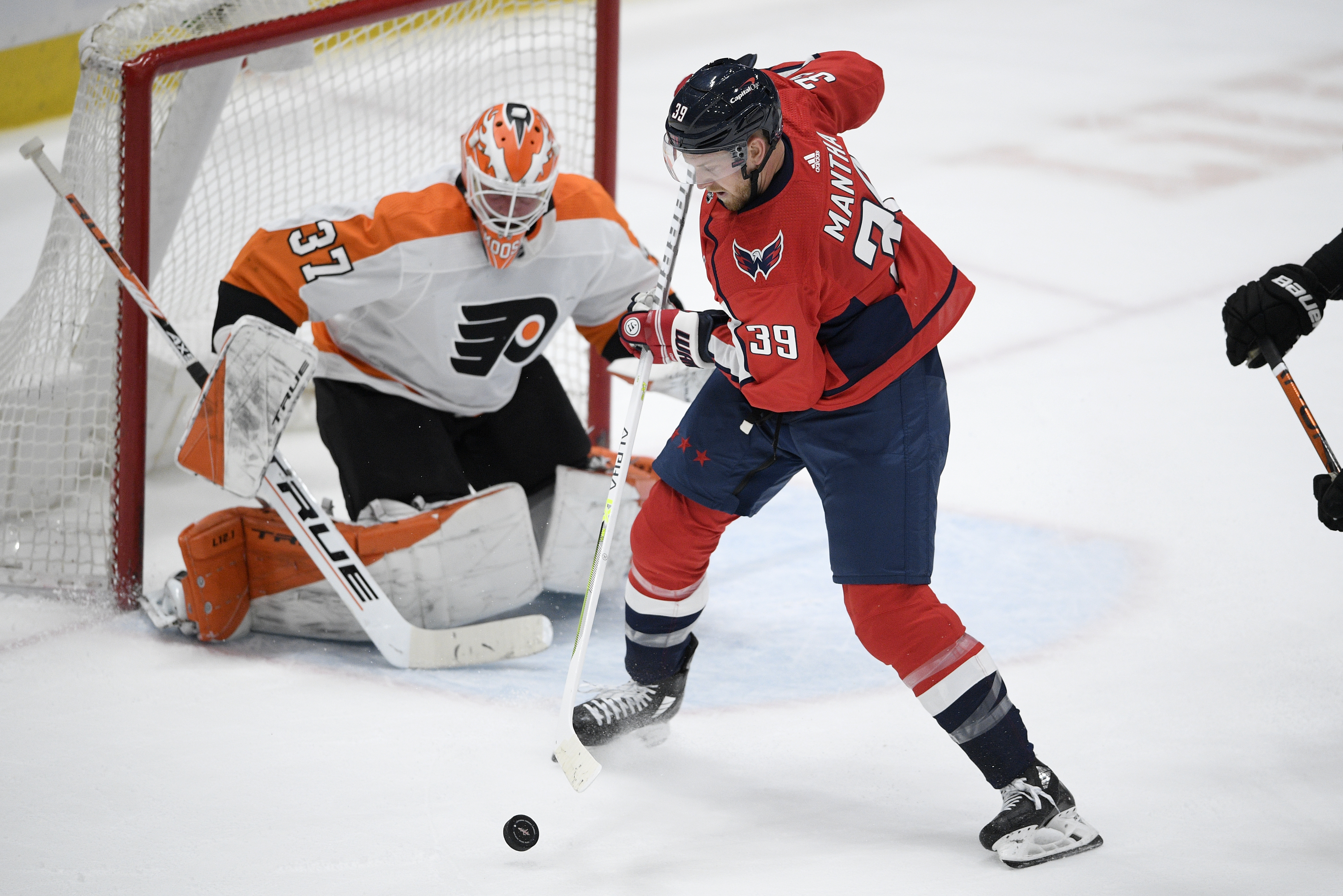 Washington Capitals' Conor Sheary, left, celebrates with T.J. Oshie after  Sheary scored a goal past Philadelphia Flyers goaltender Brian Elliott  during the first period of an NHL hockey game, Thursday, March 11