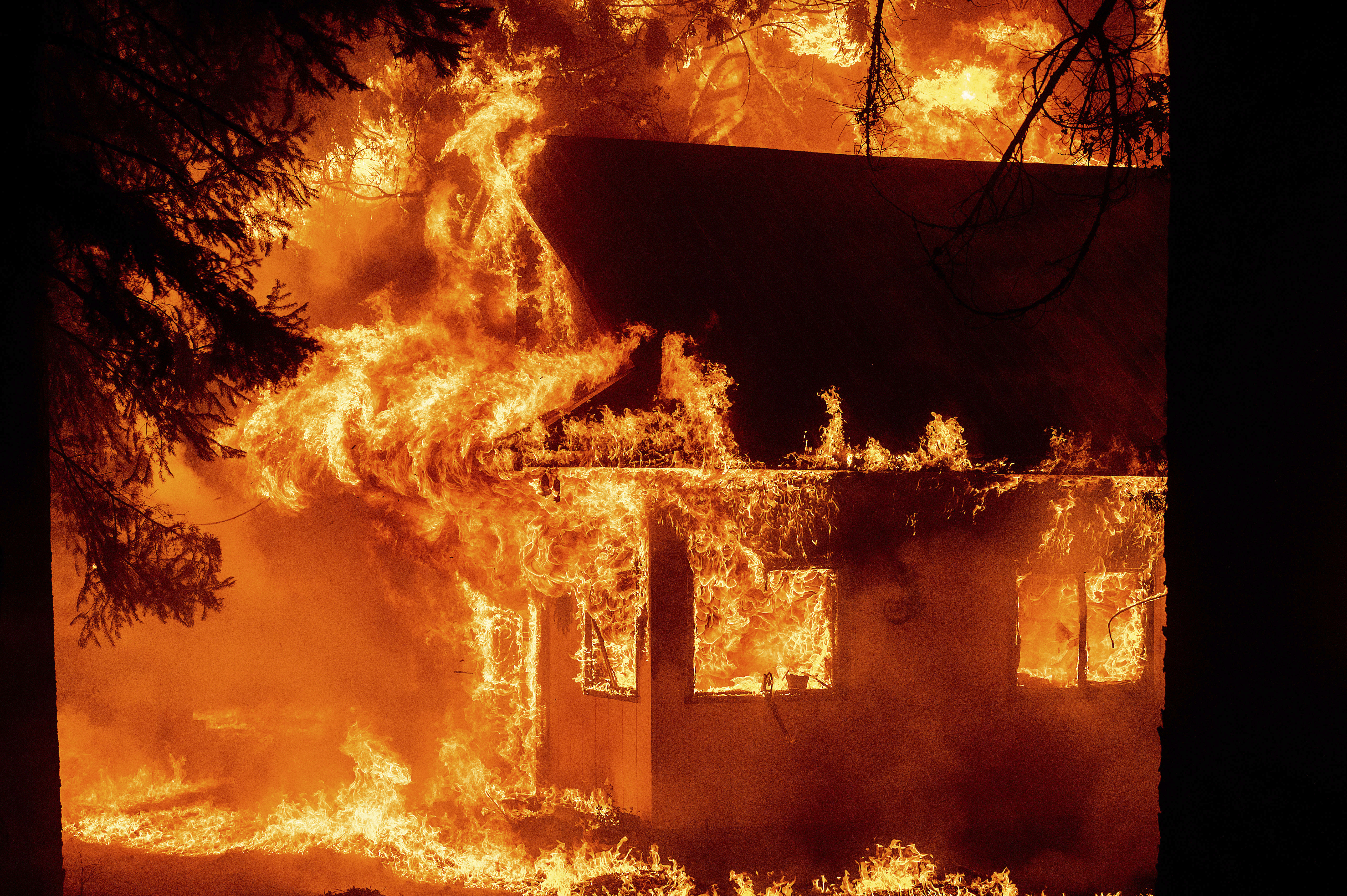 California's largest fire burns homes as blazes scorch West