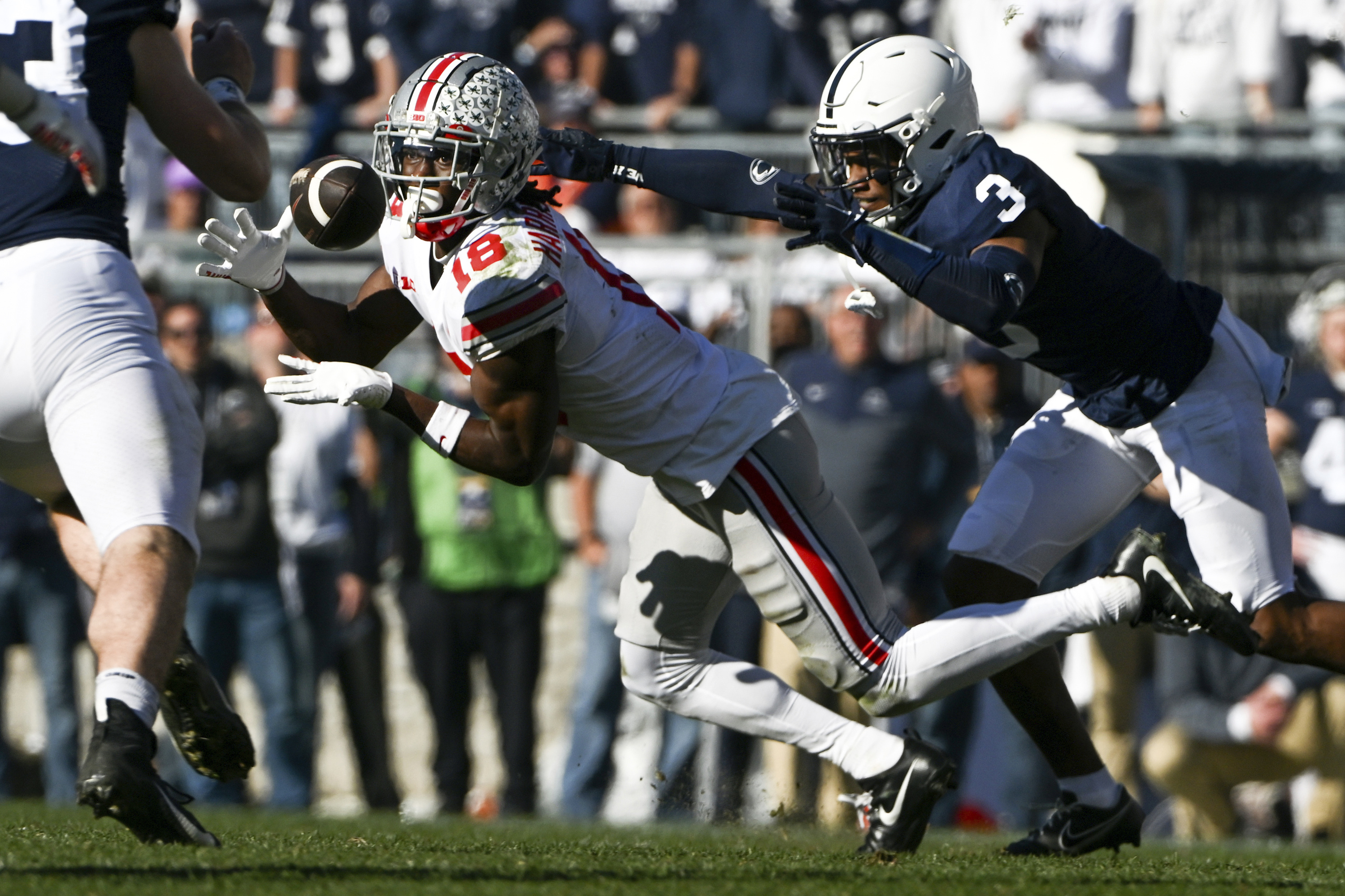 Ohio State wide receiver Marvin Harrison Jr., right, catches a touchdown  during the first half in the Rose Bowl NCAA college football game against  Utah Saturday, Jan. 1, 2022, in Pasadena, Calif. (