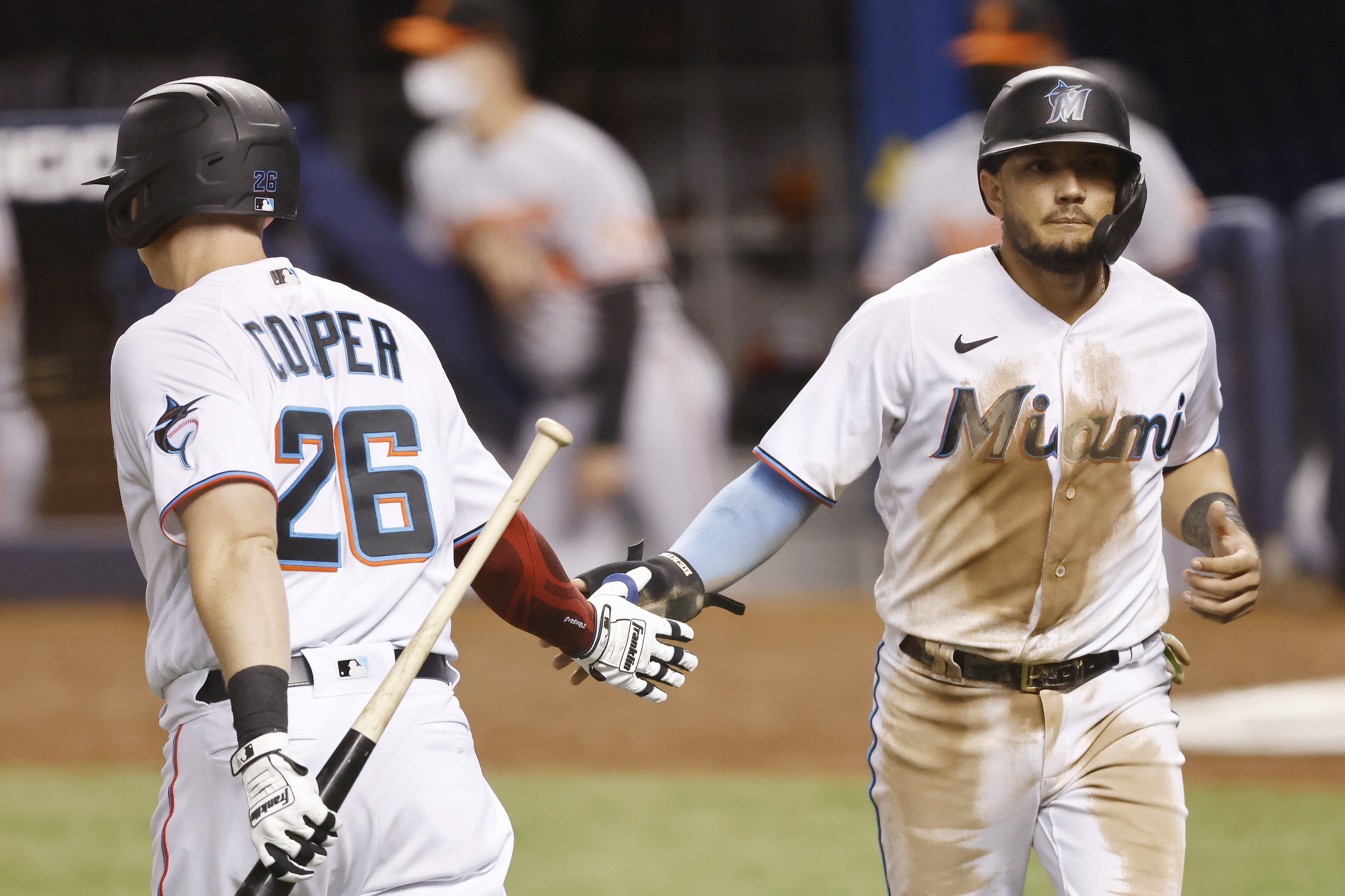 Miami Marlins first baseman Garrett Cooper (26) throws from the