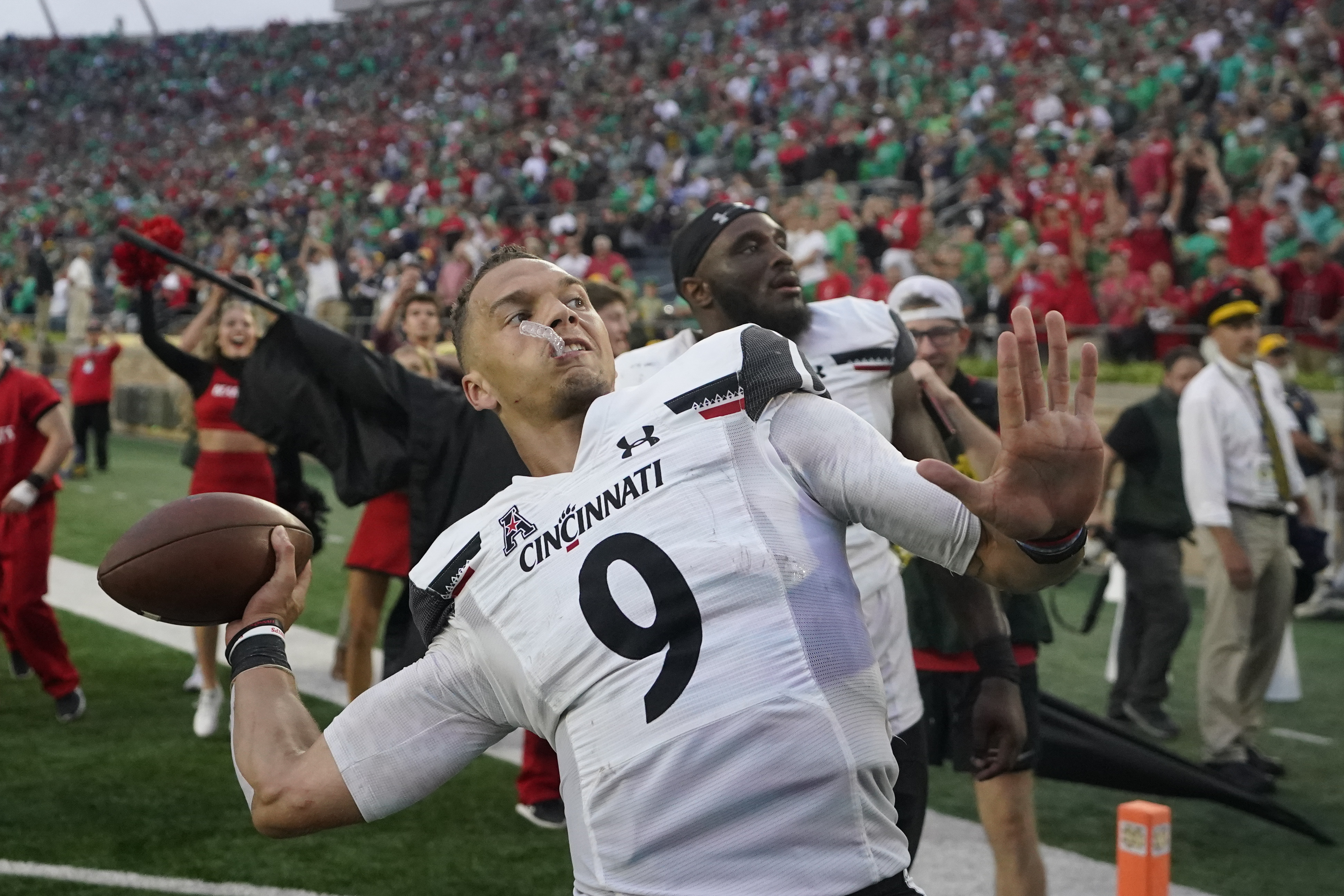 Quarterback Desmond Ridder of the Cincinnati Bearcats throws a pass