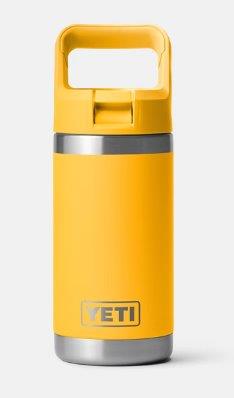 Premium Photo  Portrait of cheerful young hipster, holding steel thermo eco  bottle for water and plastic bottle, on yellow or orange wall. say no to  plastic.