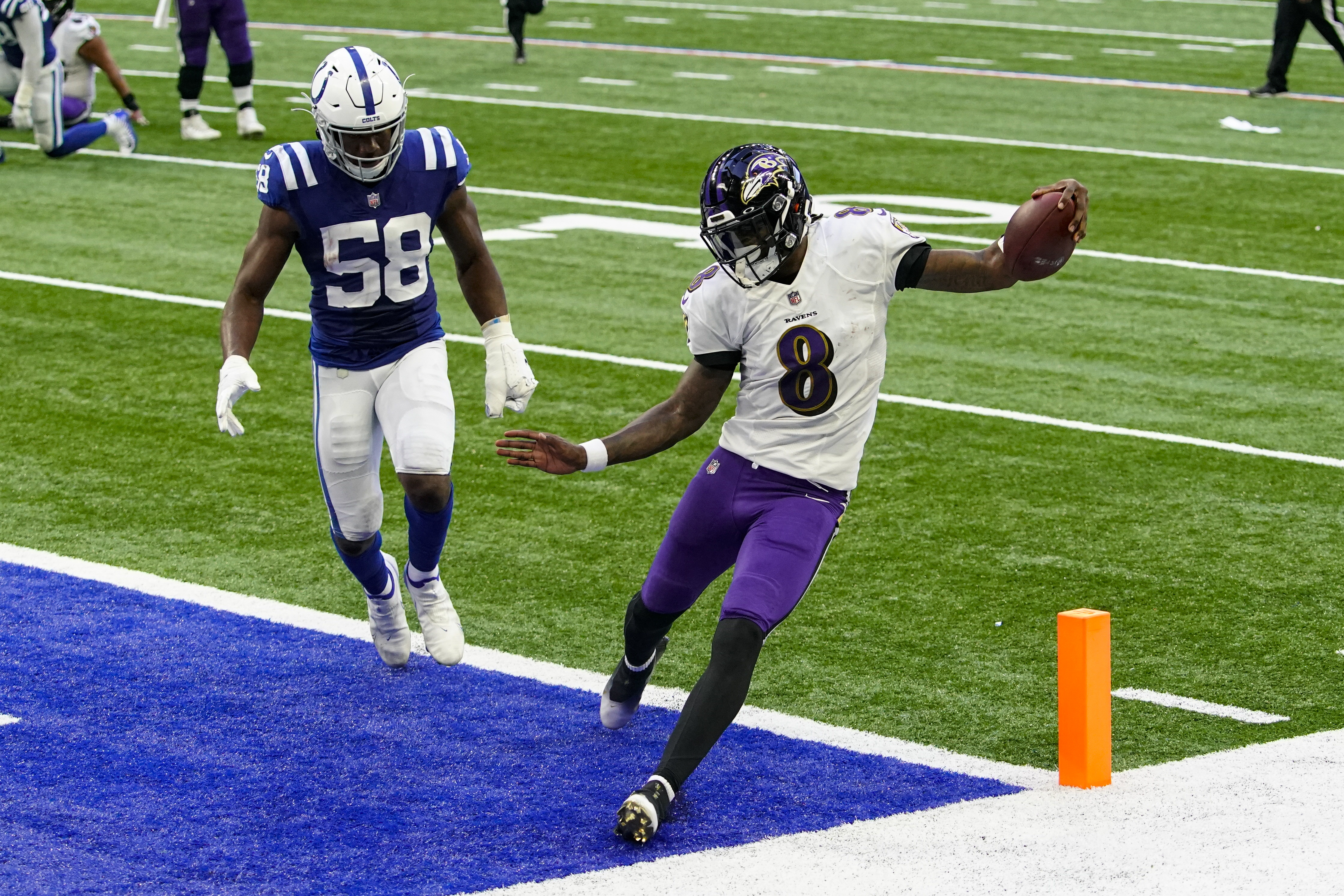 Baltimore Ravens quarterback Lamar Jackson (8) throws the ball as he is hit  by Minnesota Vikings defensive tackle Armon Watts (96) during the second  half of an NFL football game, Sunday, Nov.