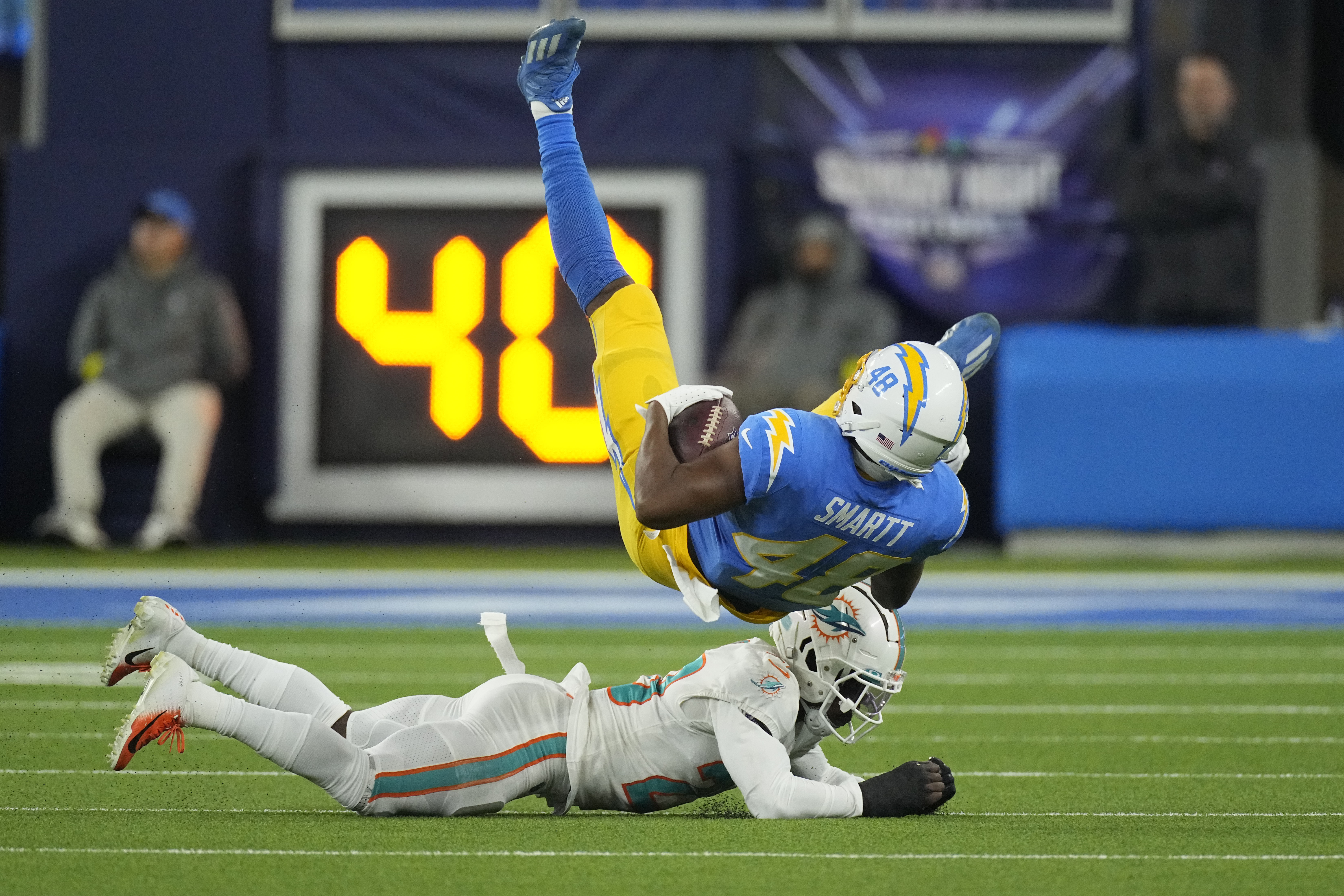 Miami Dolphins wide receiver Tyreek Hill, right, runs past Los Angeles  Chargers safety Alohi Gilman during the second half of an NFL football game  Sunday, Sept. 10, 2023, in Inglewood, Calif. (AP