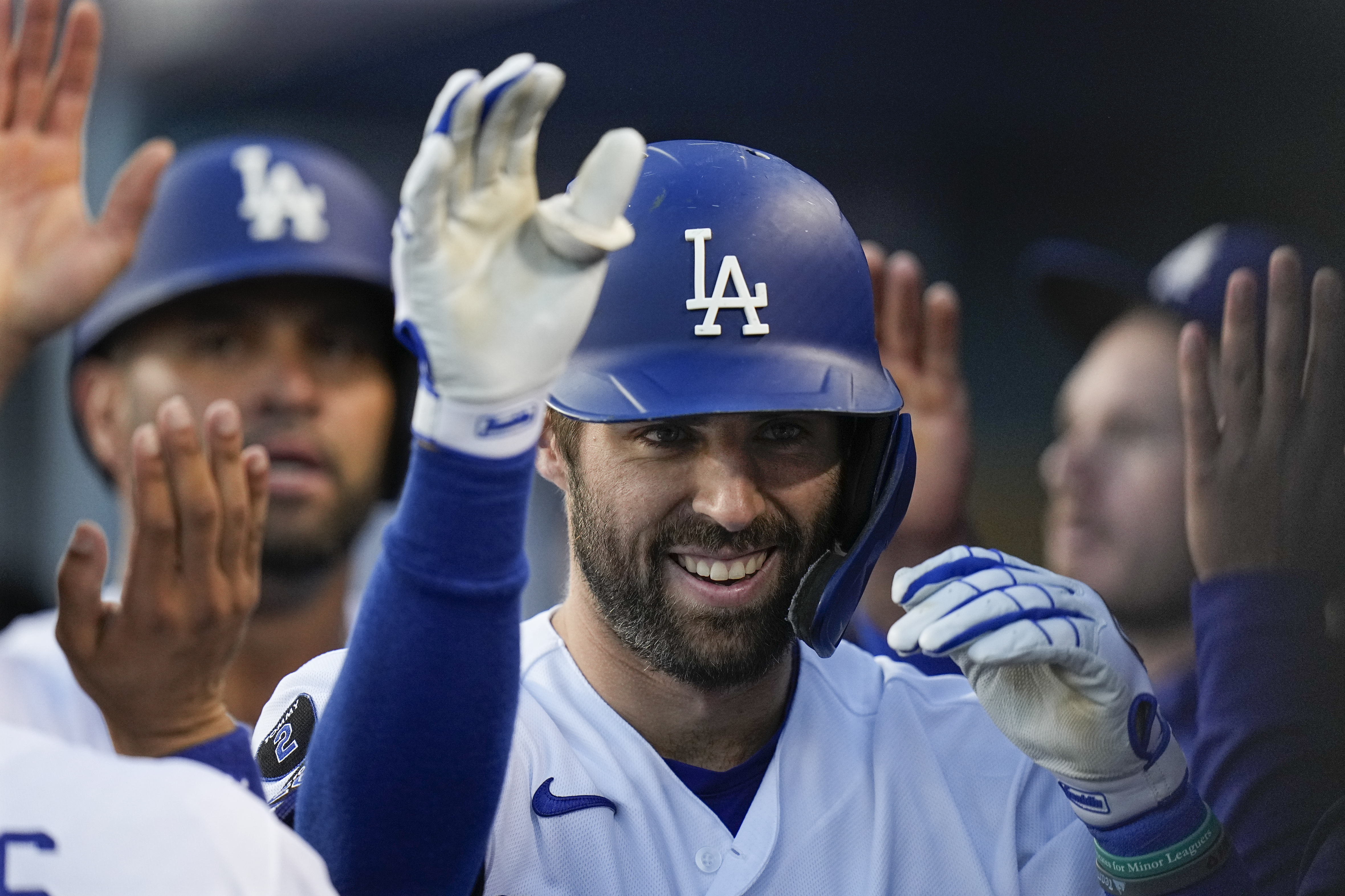 Cody Bellinger of the Los Angeles Dodgers hugs teammate Corey