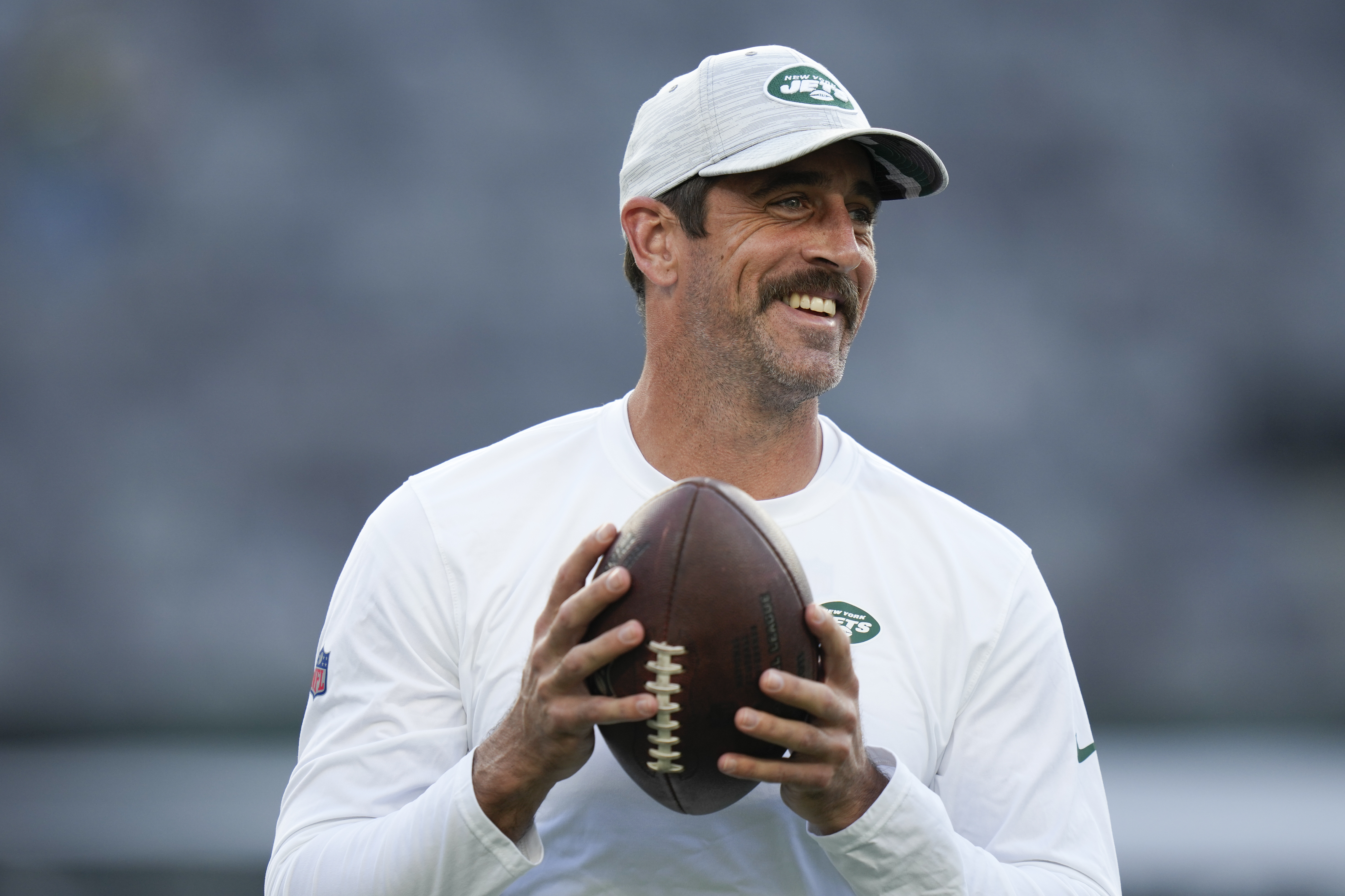 New York Jets quarterback Aaron Rodgers (8) stands on the sidelines during  the first half of an NFL preseason football game against the New York Giants,  Saturday, Aug. 26, 2023, in East