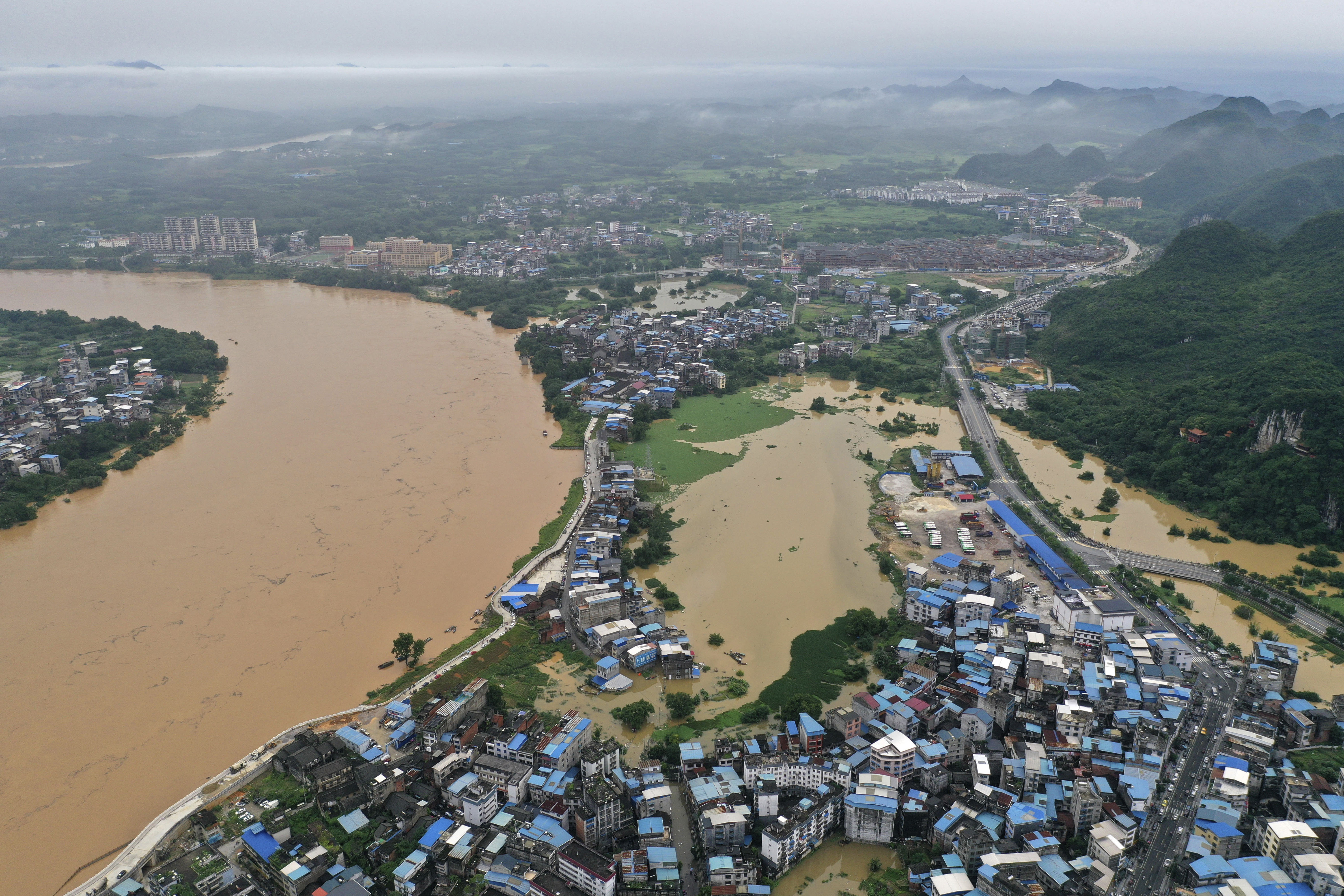 Floodwater gush out from the Jinxi Reservoir in Yongjia county, Wenzhou  city, east China's Zhejiang province, 10 July 2019. Aerial photos taken on  10 July 2019 showed water gushing out from the