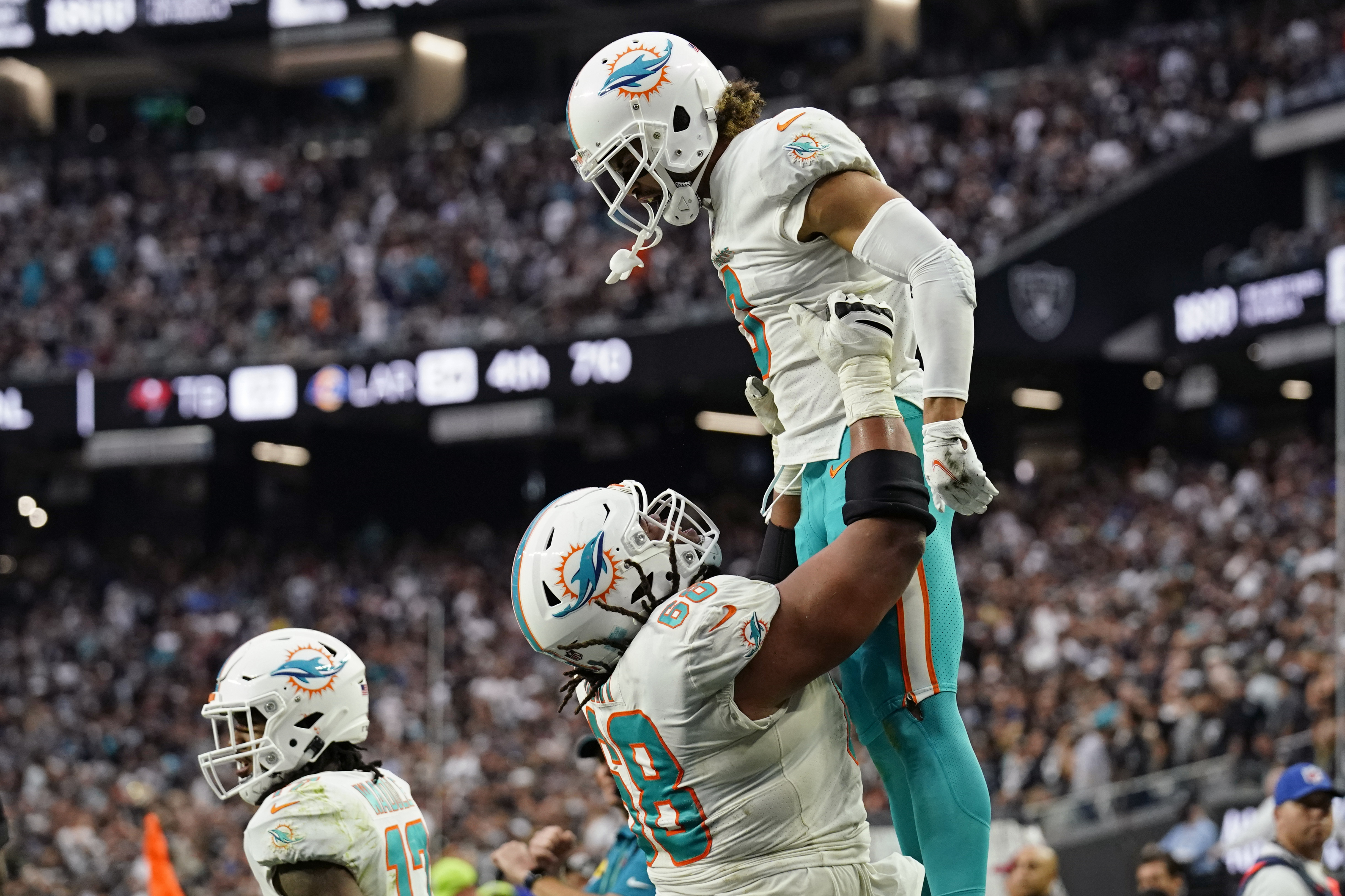 Miami Dolphins running back Malcolm Brown (34) scores a touchdown against  the Las Vegas Raiders during the first half of an NFL football game,  Sunday, Sept. 26, 2021, in Las Vegas. (AP