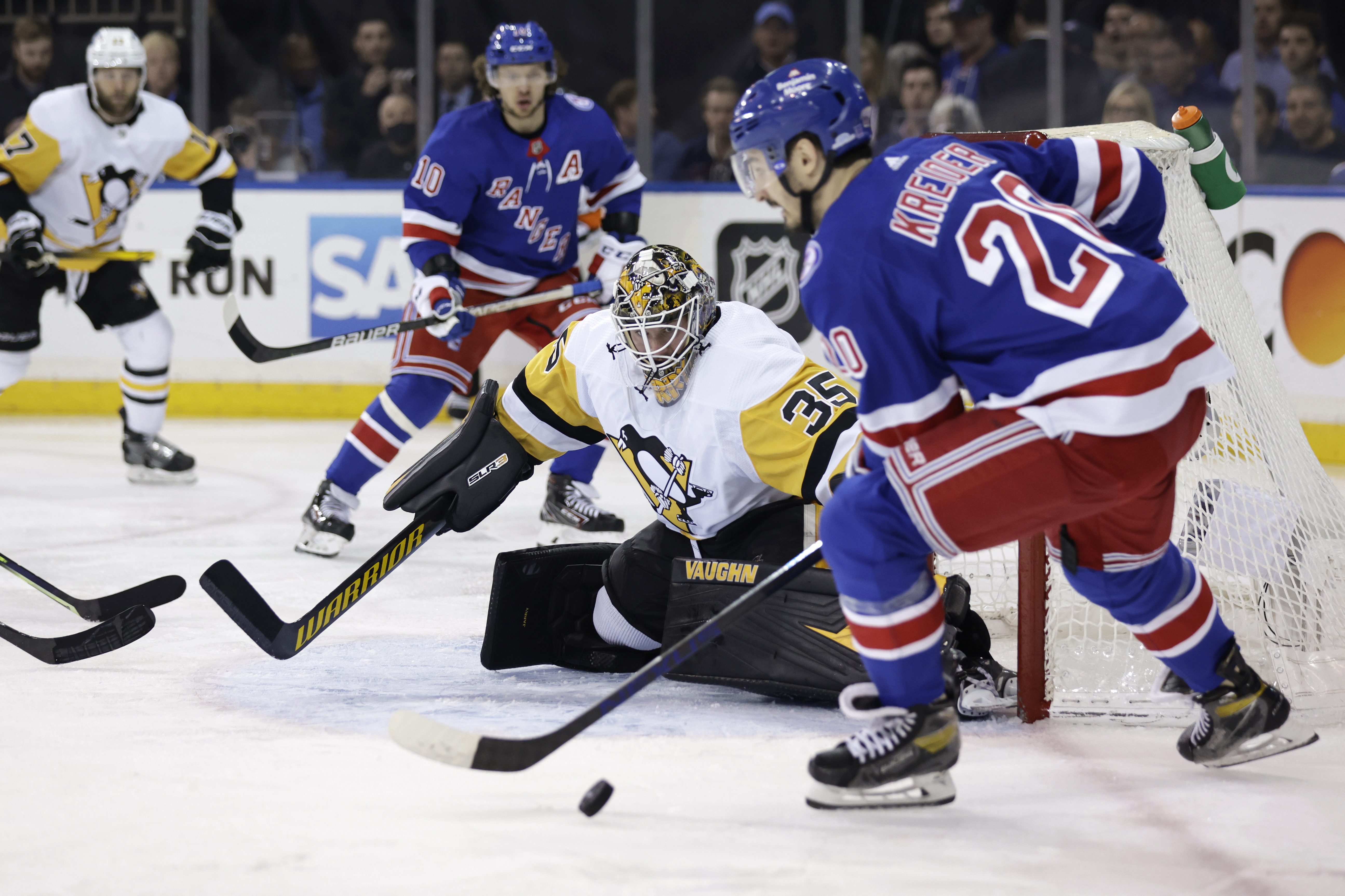 Pittsburgh Penguins center Sidney Crosby (87) punches New York Rangers  defenseman K'Andre Miller during the second overtime of Game 1 of an NHL  hockey Stanley Cup first-round playoff series Tuesday, May 3